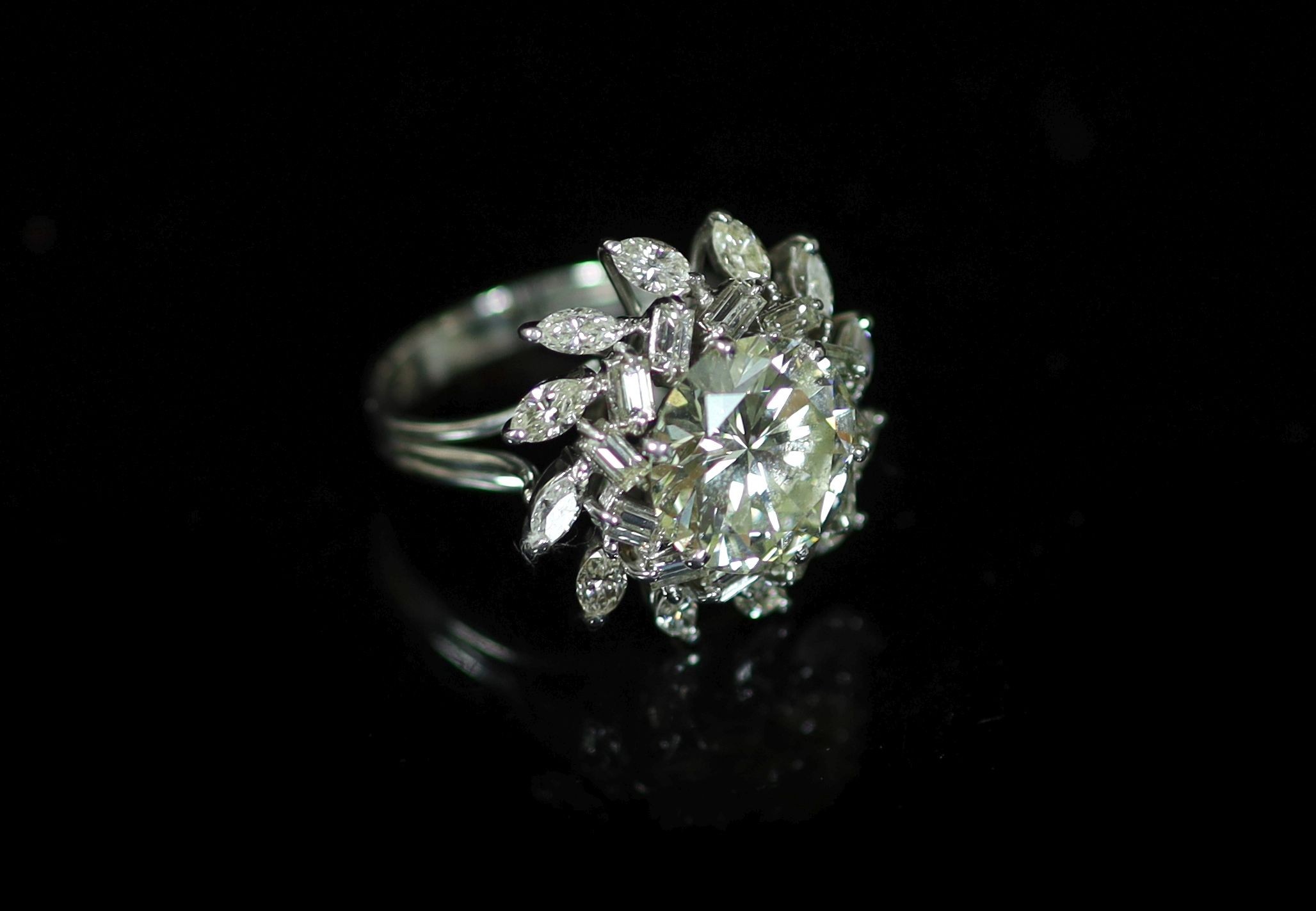 A platinum and single stone diamond ring, with baguette and marquise cut diamond foliate setting                                                                                                                            