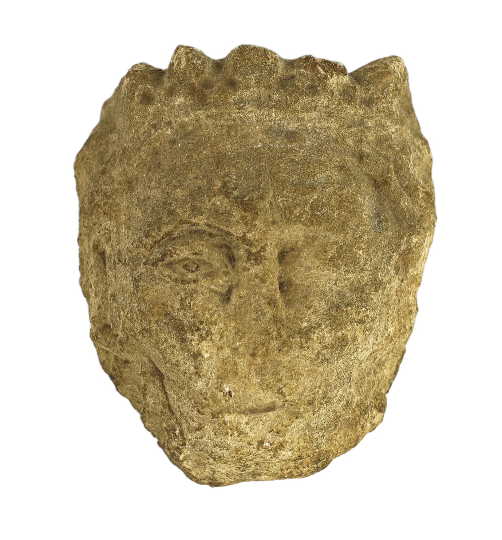 An English carved limestone head of a bearded king, possibly Anglo-Saxon, 25cm high 22.5cm wide                                                                                                                             