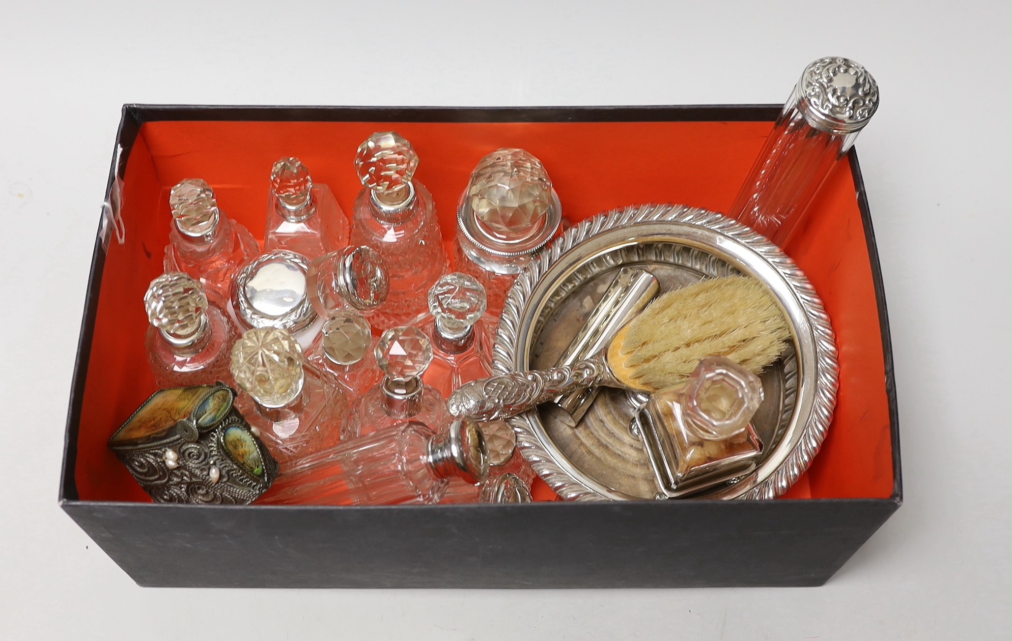 A collection of assorted silver mounted glass scent bottles and other items including a wine coaster etc.                                                                                                                   