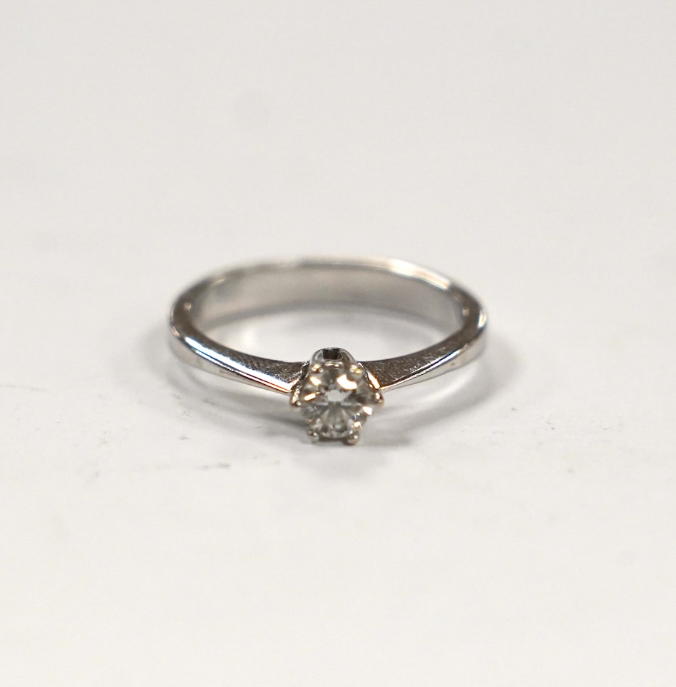 A 14k white metal and solitaire diamond set ring, size H, gross weight 2 grams.                                                                                                                                             