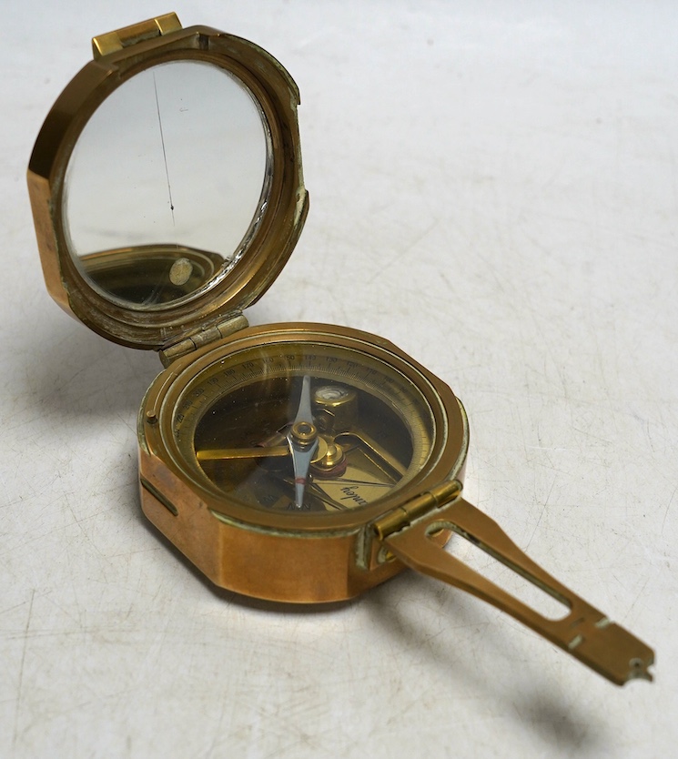 A Stanley brass cased compass with internal spirit level, and a panel with engraved Natural Sine table applied to the lid. Condition - good                                                                                 