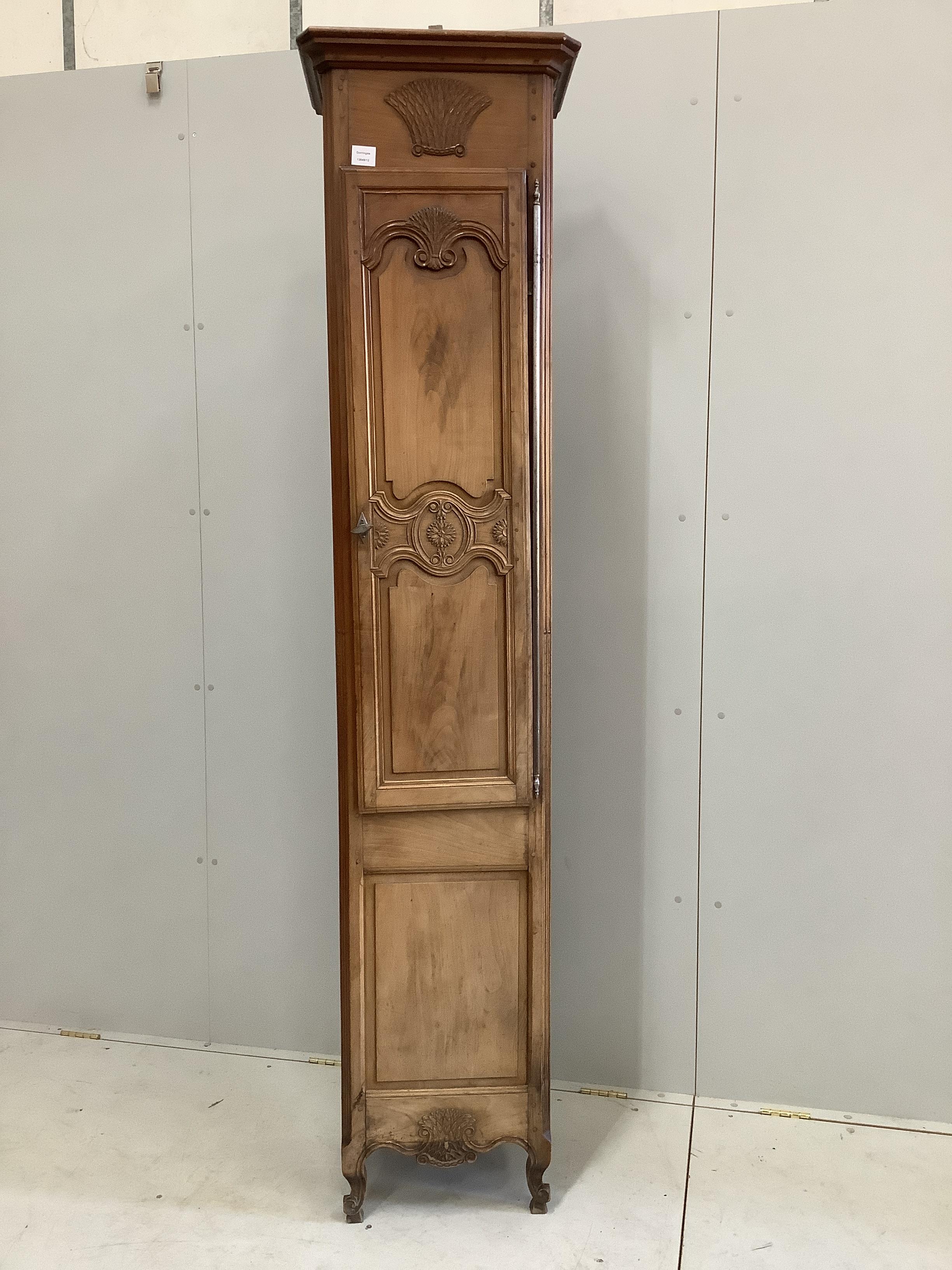 A Louis XV style narrow walnut cabinet, width 48cm, depth 36cm, height 215cm                                                                                                                                                