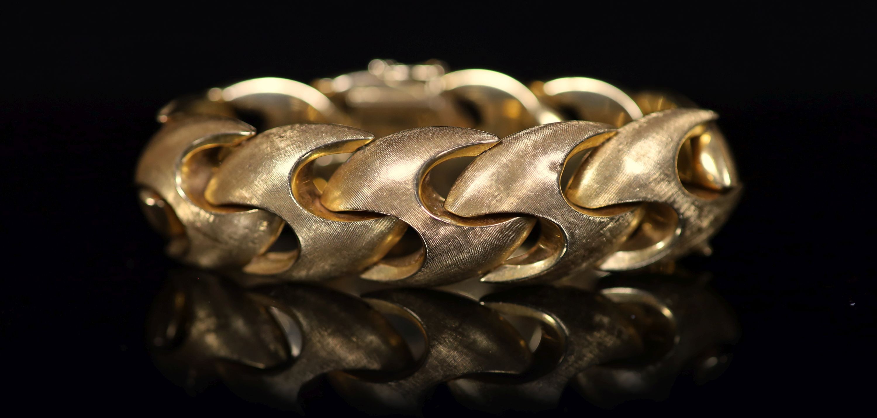 A 1970's brushed 18ct gold bracelet, 18.5cm, 57.3 grams.                                                                                                                                                                    