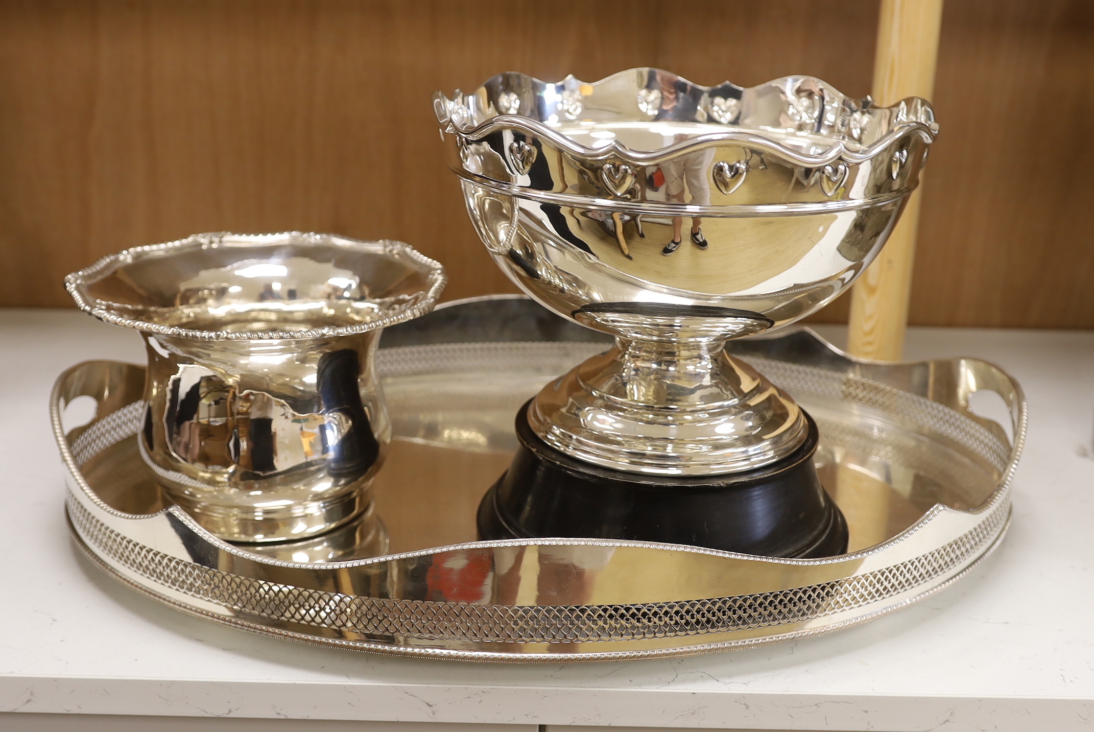 A plated galleried oval tray, an Arts & Crafts style punch bowl and bottle coaster, tray 60cm wide                                                                                                                          