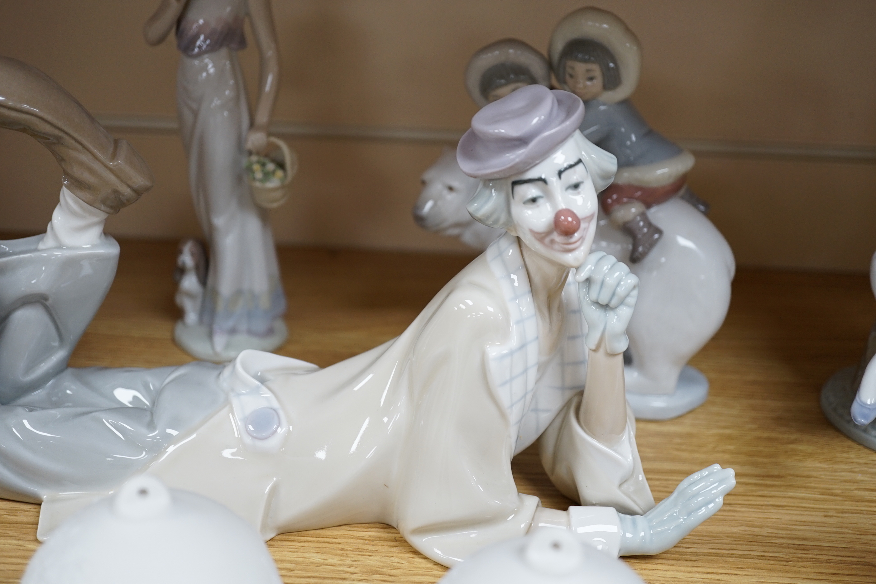 Seven Lladro figures including a clown together with three Lladro bells, the clown 37cm wide                                                                                                                                