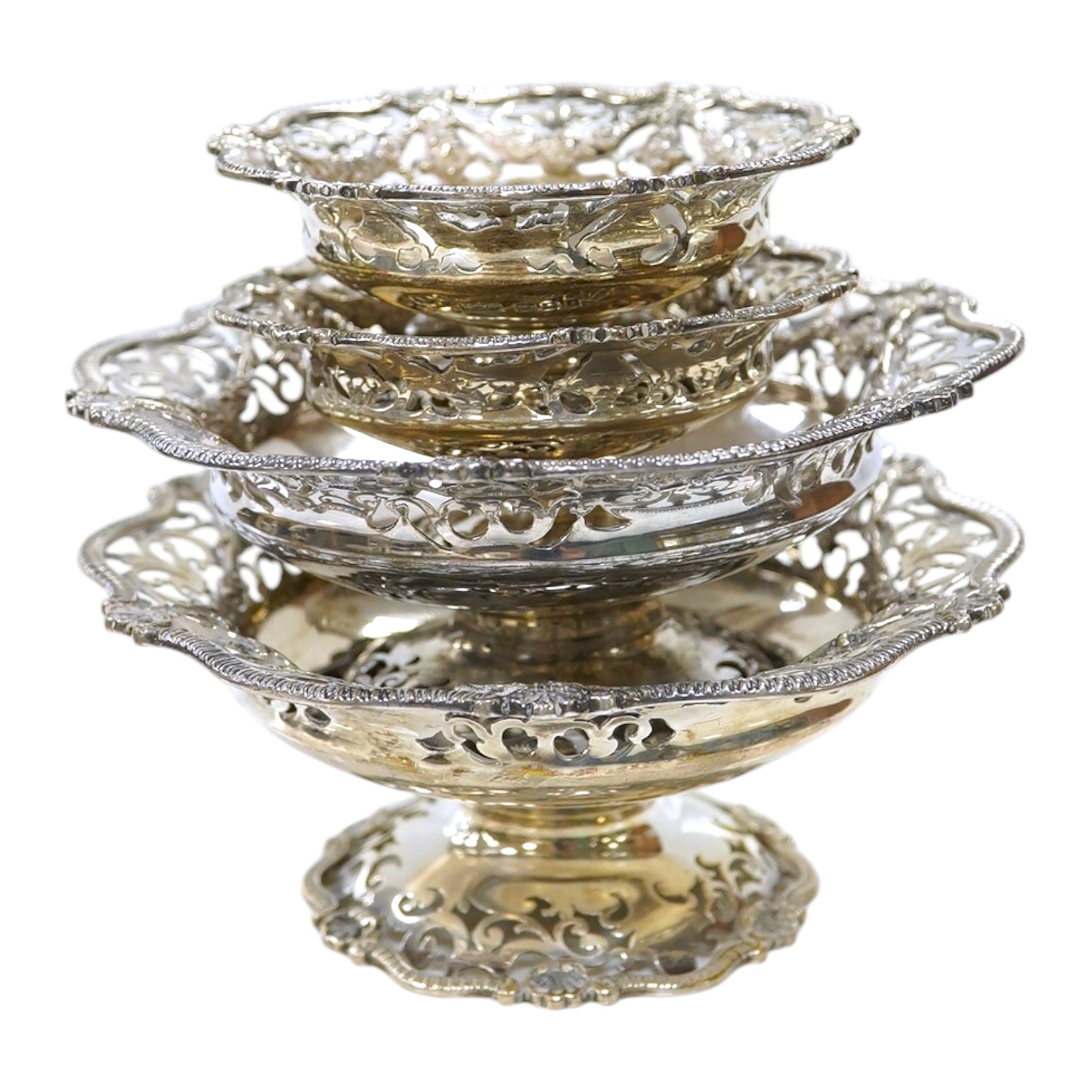 Two graduated pairs of George V pierced silver bon bon dishes, makers Mappin & Webb, 1924, diameter 13cm and 9cm, 17oz. Condition - good                                                                                    