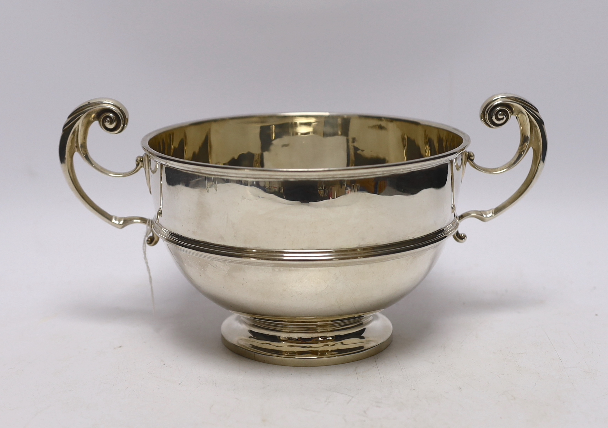 An Edwardian silver two handled bowl, with banded girdle, Goldsmiths & Silversmiths Co Ltd, London, 1908, 27cm over handles, 18.5oz.                                                                                        