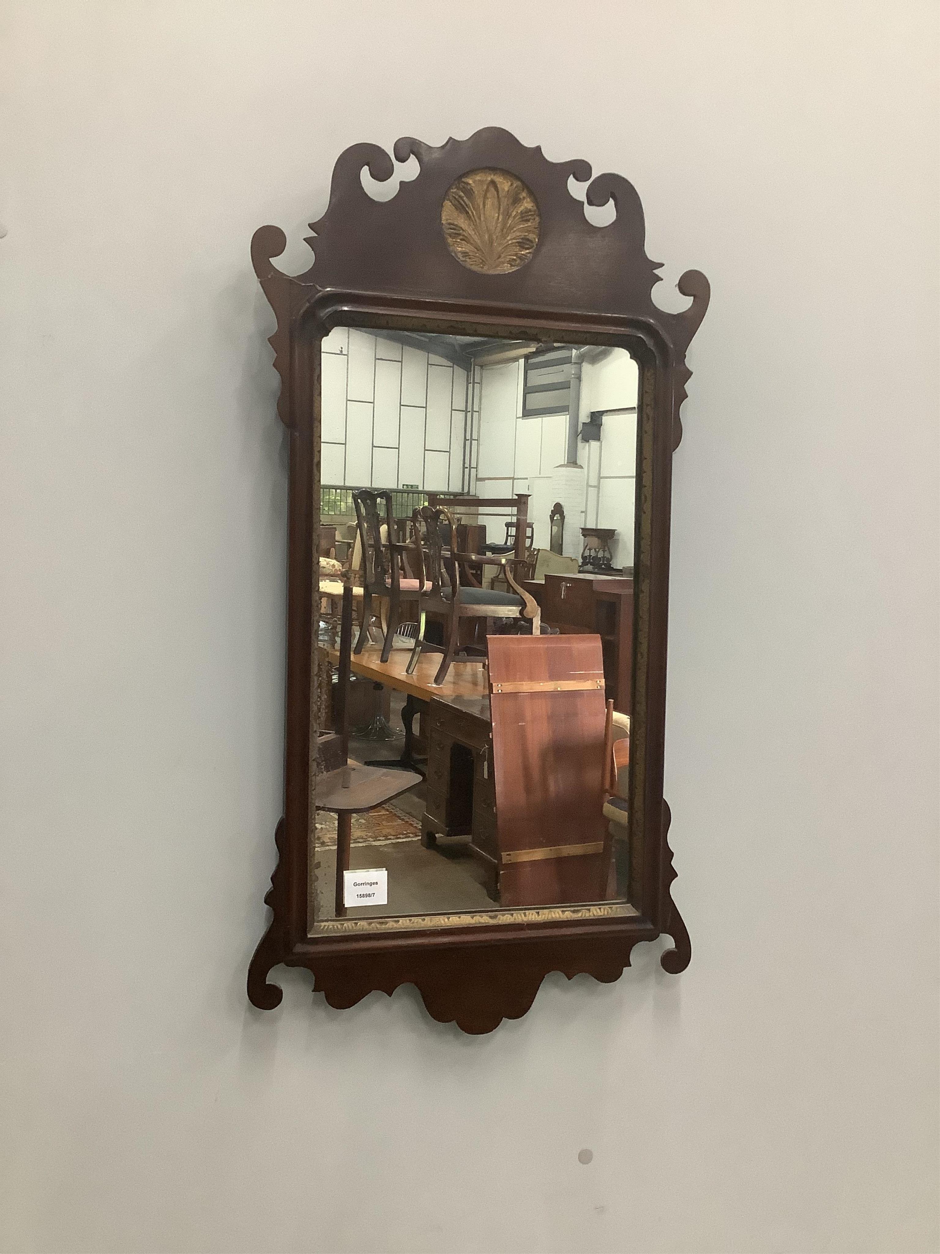 A George III style parcel gilt mahogany fret cut wall mirror, width 44cm, height 86cm. Condition - fair                                                                                                                     