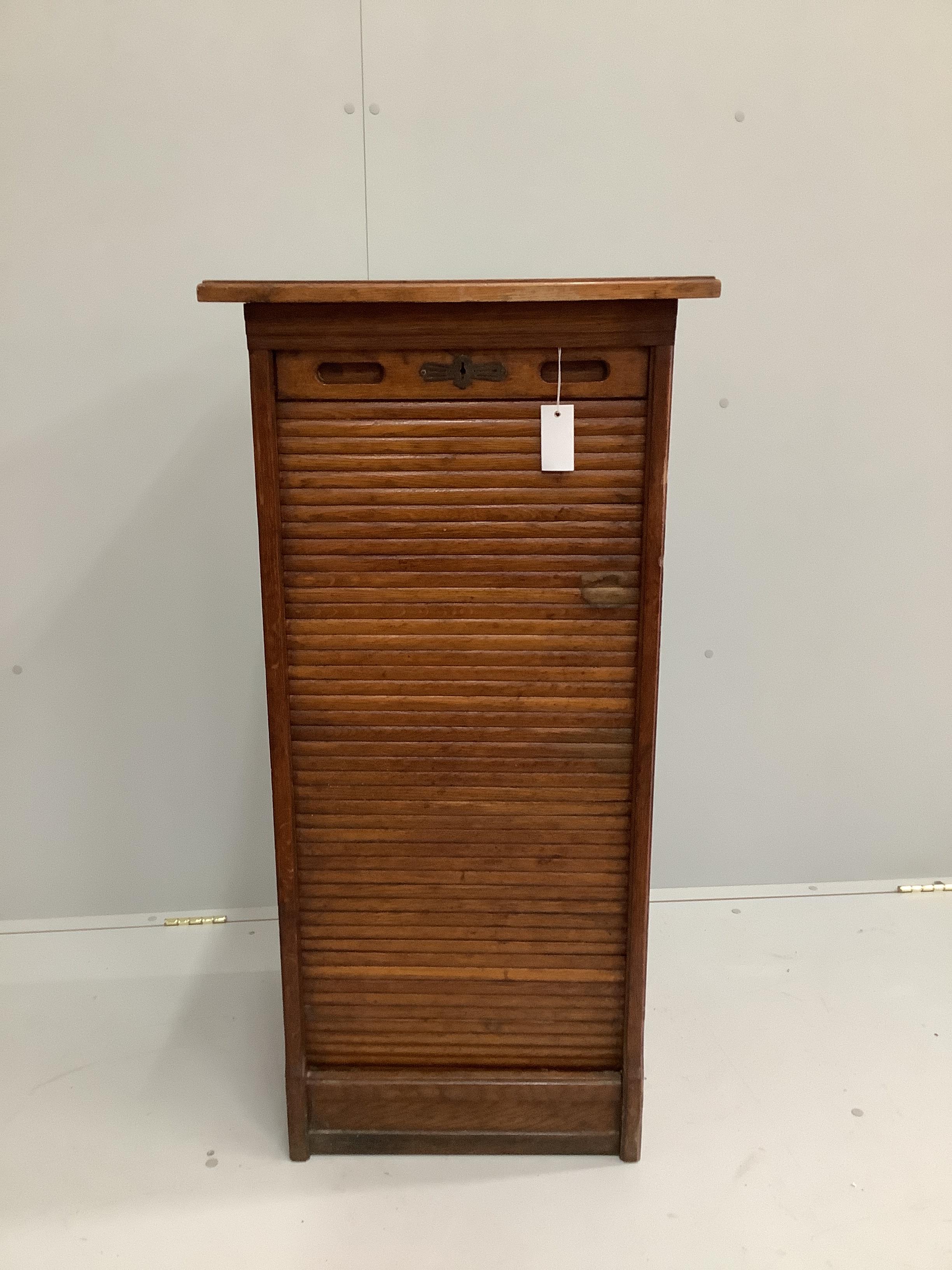 A 1920's oak tambour filing cabinet, width 52cm, depth 48cm, height 109cm                                                                                                                                                   