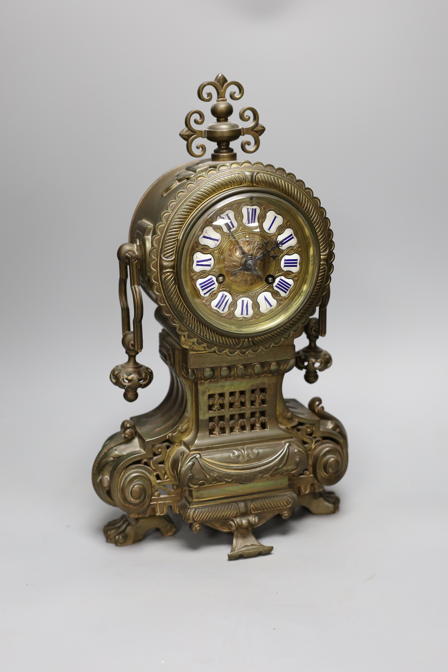 A late 19th century French brass cased mantel clock, 41 cms high                                                                                                                                                            