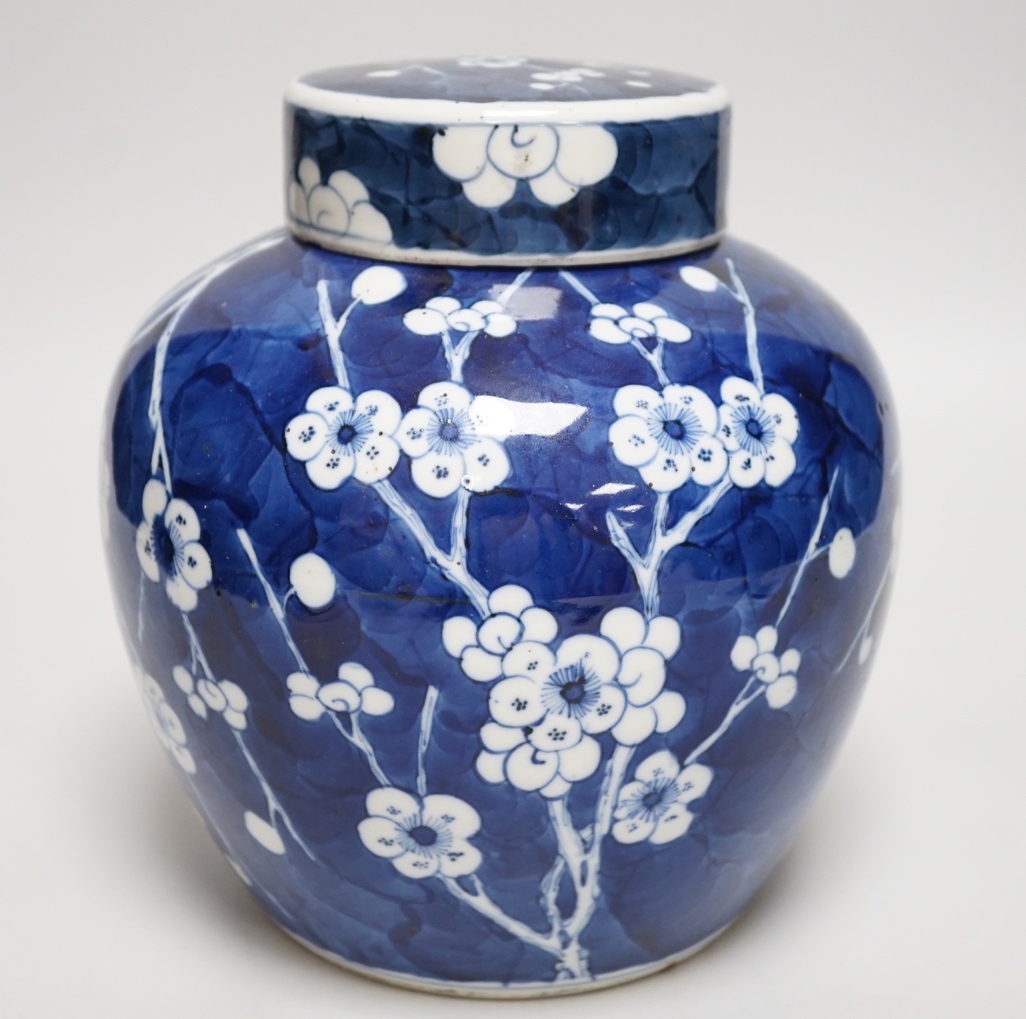 A Chinese blue and white prunus jar and cover, late 19th century, 20.5cms high                                                                                                                                              