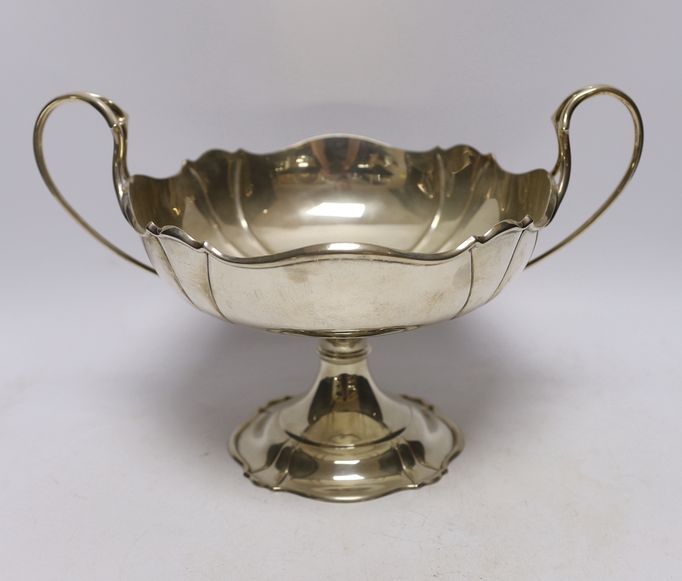 A George V silver two handled pedestal fruit bowl, by Atkin Brothers, Sheffield, 1911, 32.6cm over handles, 26oz.                                                                                                           