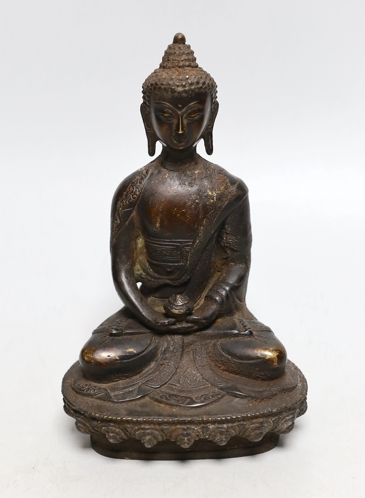 A Himalayan bronze figure of Buddha, 19.5cms high                                                                                                                                                                           