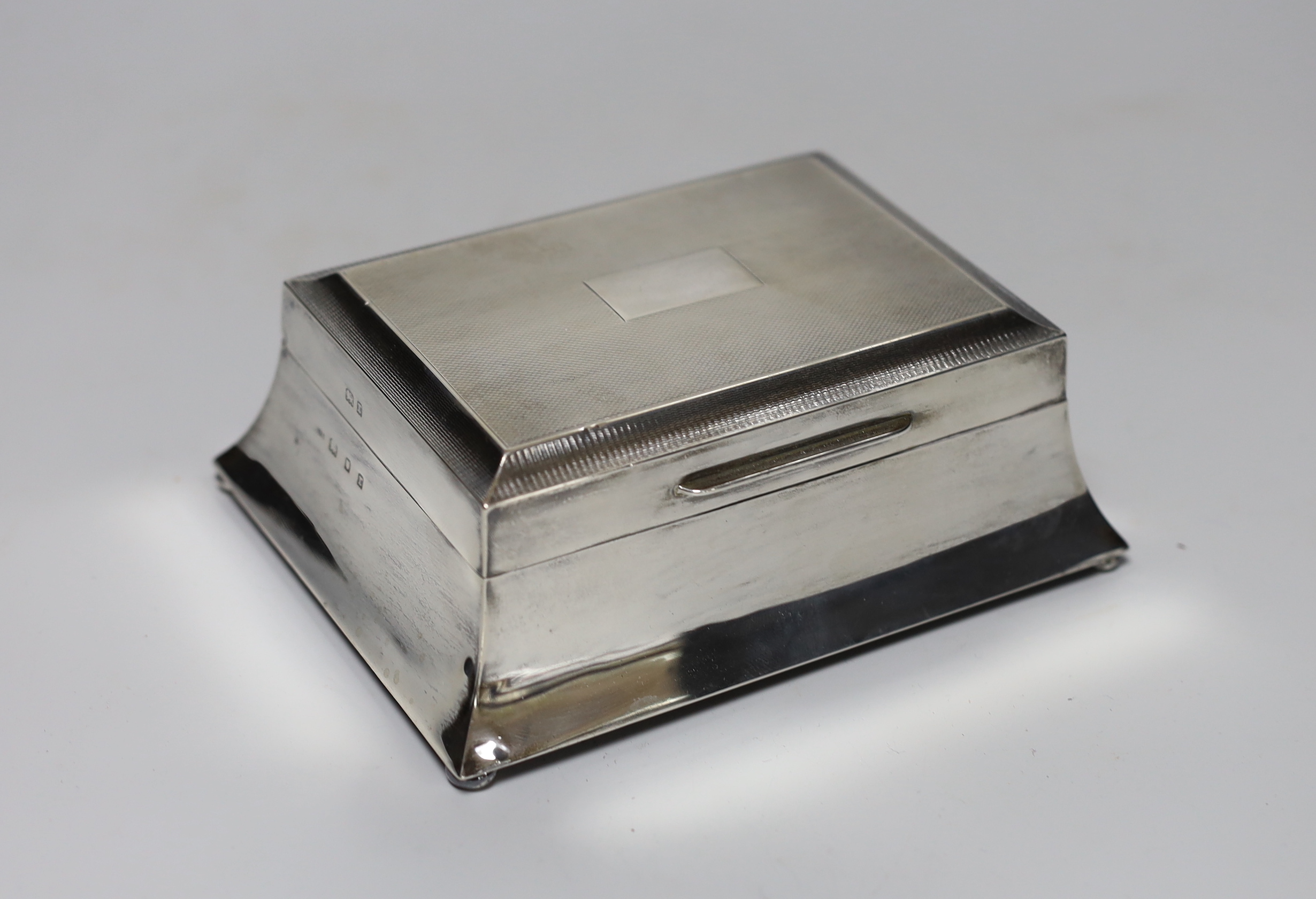 A George V Art Deco part engine turned silver mounted rectangular cigarette case, London, 1932, 15.2cm.                                                                                                                     