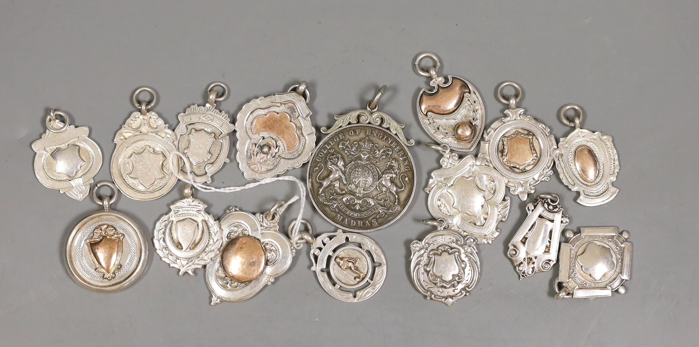 Fifteen assorted silver prize medallions, some with gold overlay, gross 113 grams, and a Madras College of Engineering medallion dated 1912                                                                                 
