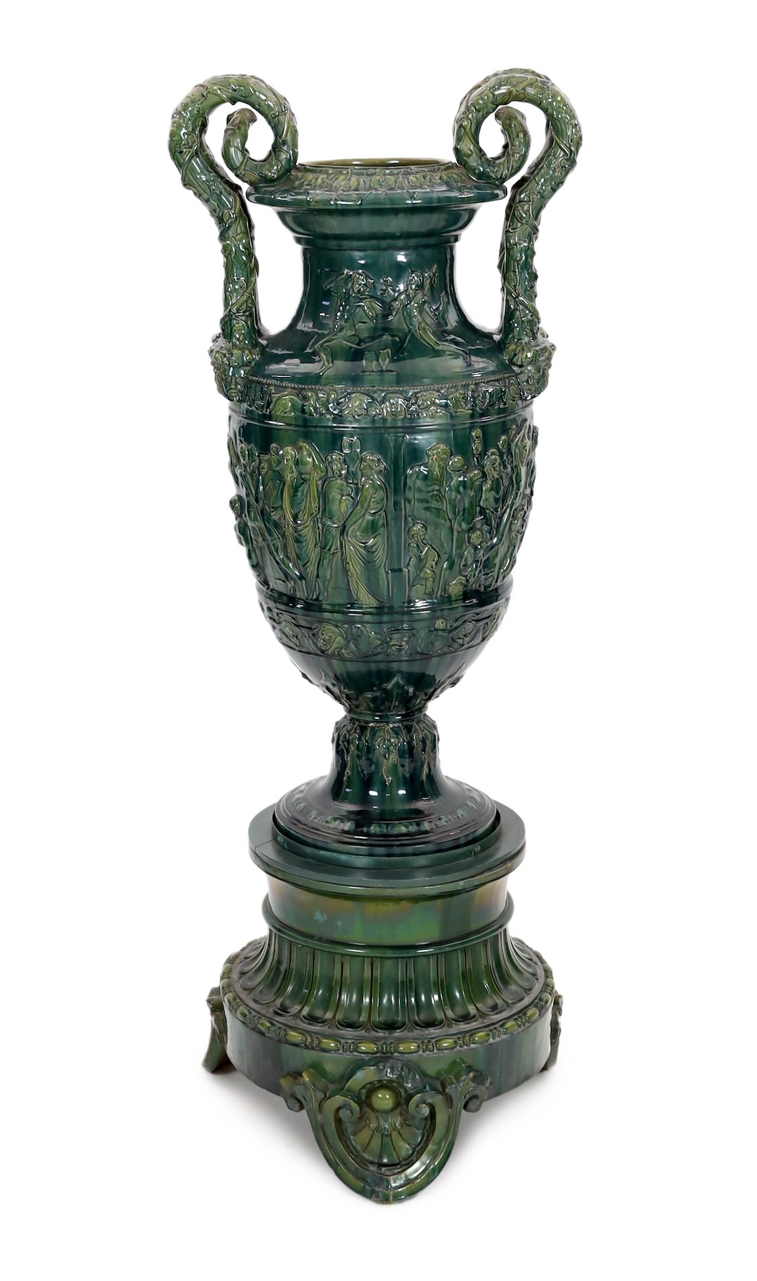 A massive Continental majolica green glazed campana vase and associated stand, late 19th century, total height 153cm, small repairs                                                                                         