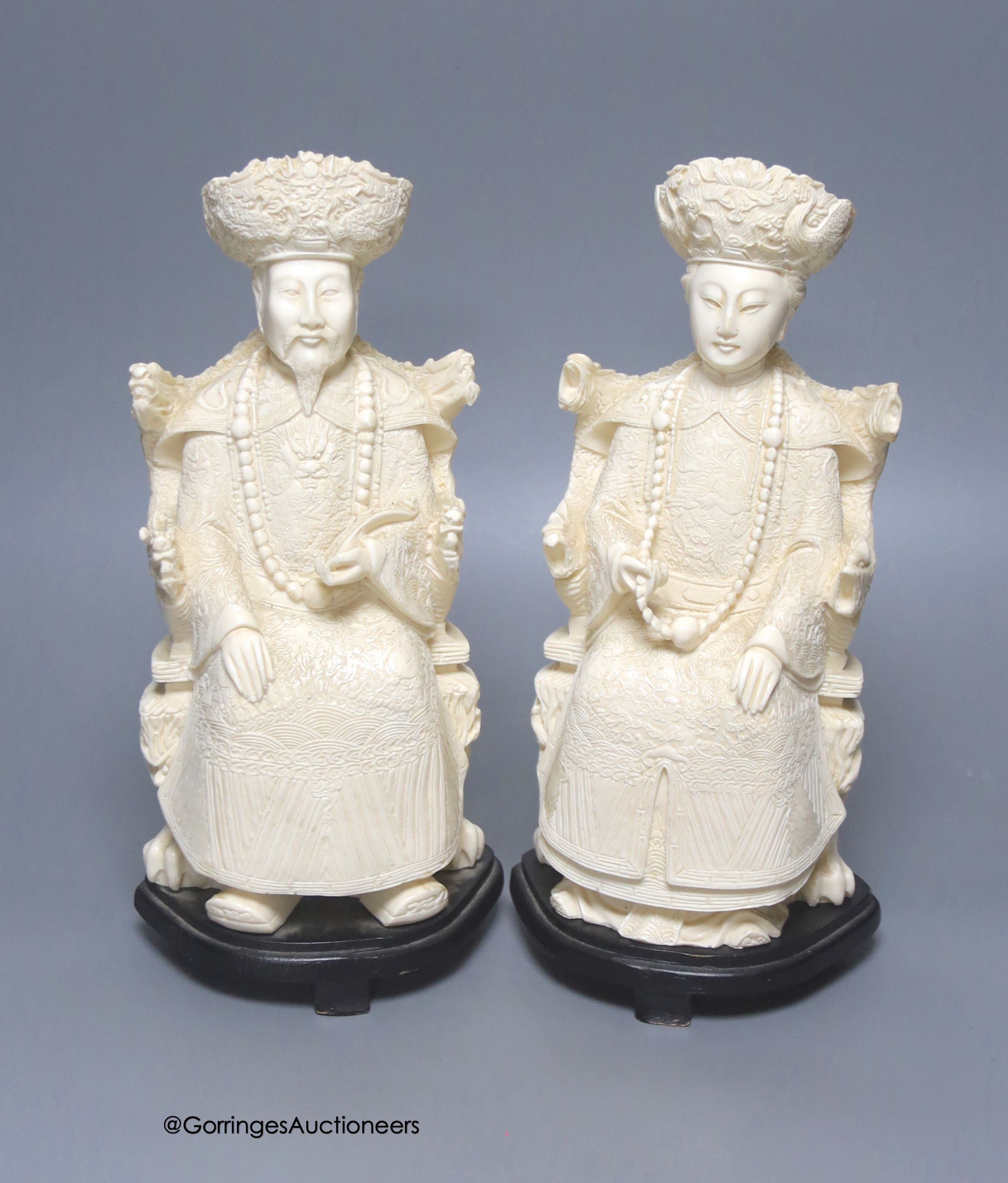 A pair of mid 20th century Chinese faux ivory figures of an Emperor and Empress, height 31cm                                                                                                                                