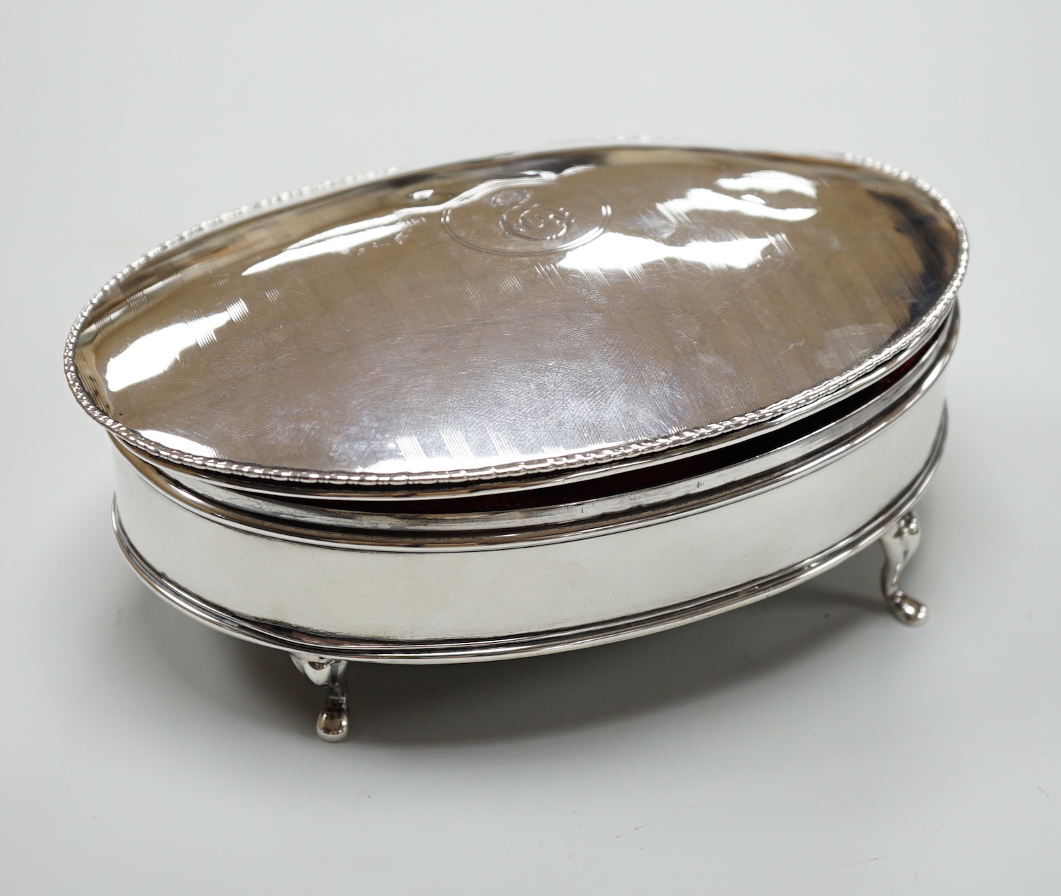 A George V silver mounted oval trinket box, by Sydney & Co, Birmingham, 1915, 16.3cm.                                                                                                                                       