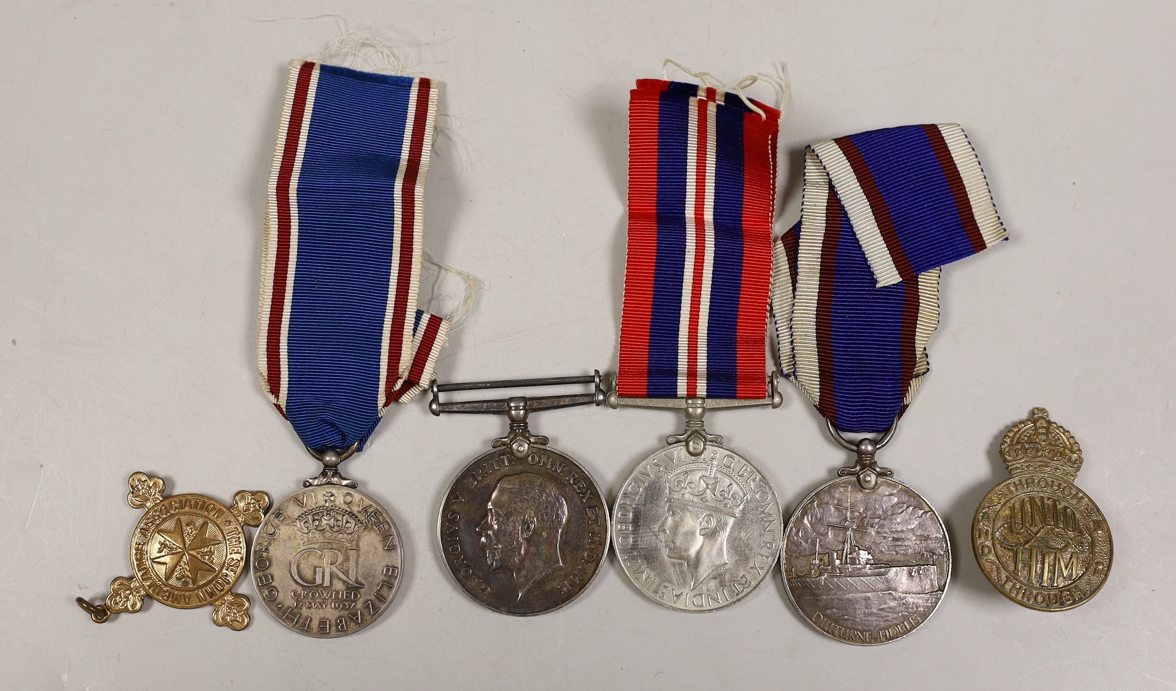 A George VI Royal Fleet Reserve medal, to J. 106331 (DEV. B. 16234) E. J. Shepherd. A.B. R.F.R., a George VI coronation medal, WWI war medal to 13995 CPL.J.L. Grover Duke of Corwall's Light Infantry and two badges       