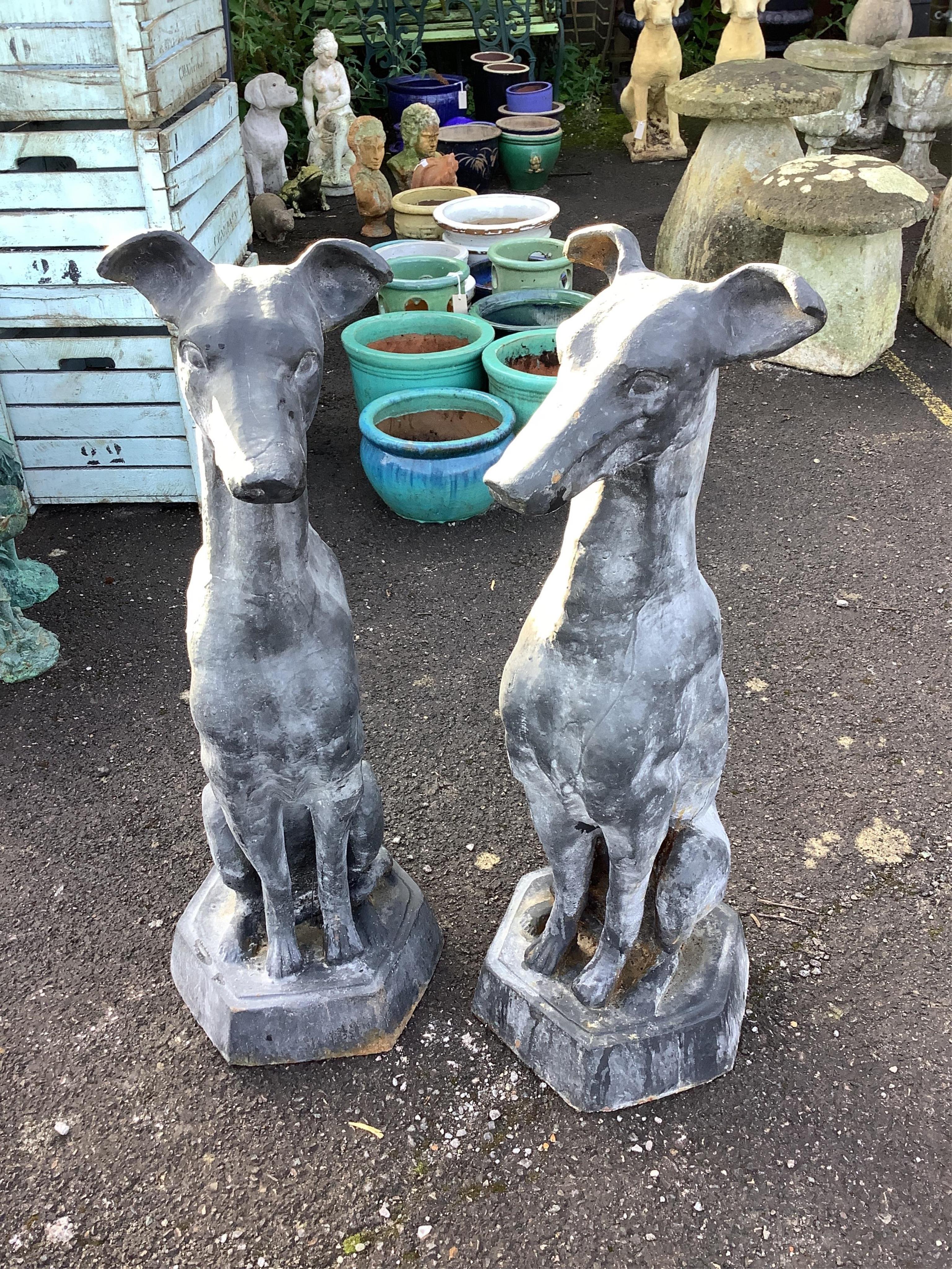 A pair of black painted cast iron models of seated hounds, height 91cm. Condition - weathered                                                                                                                               