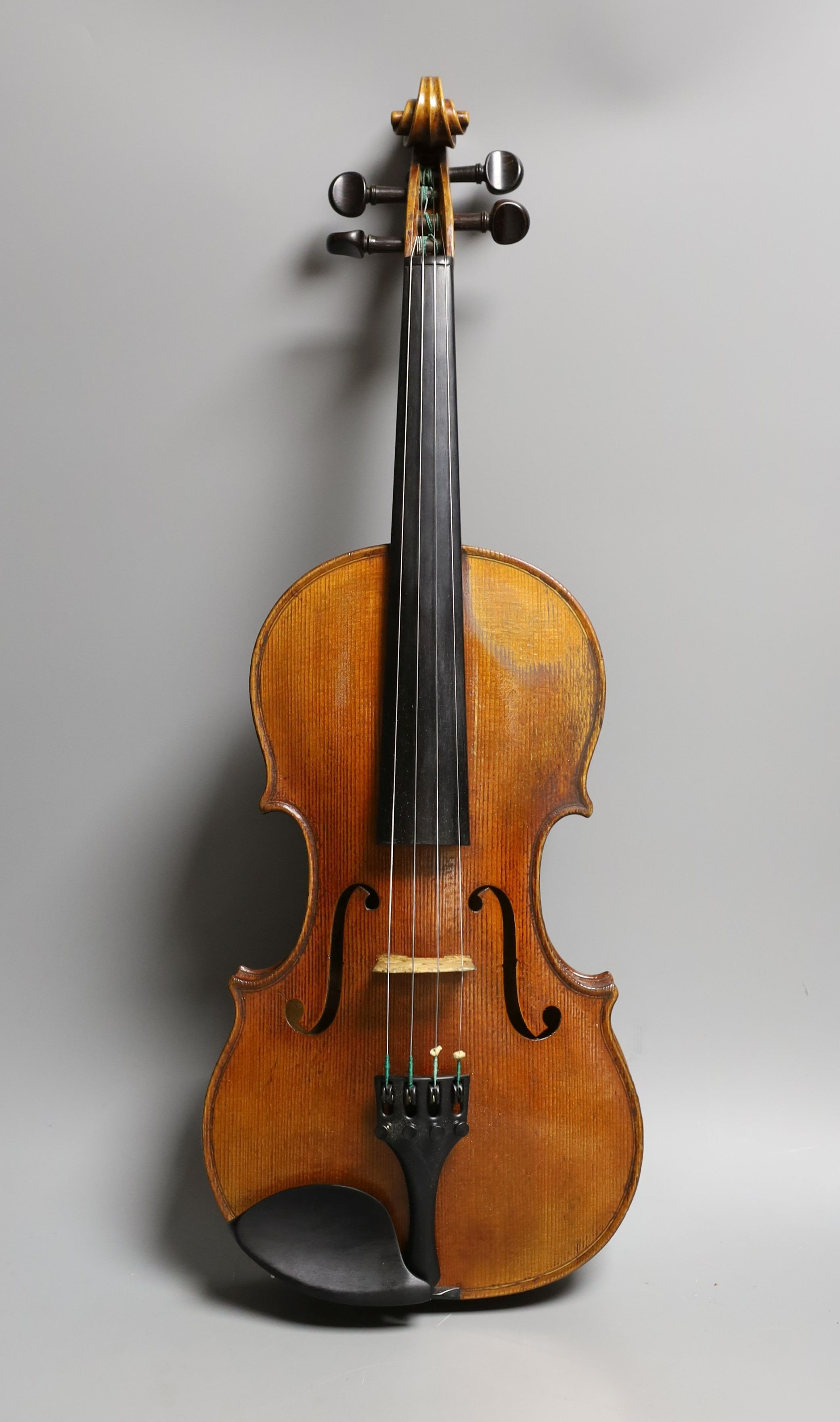 A 19th century violin labelled JB Guadagnini, back measures 35cm, with two bows, one silver-mounted.                                                                                                                        