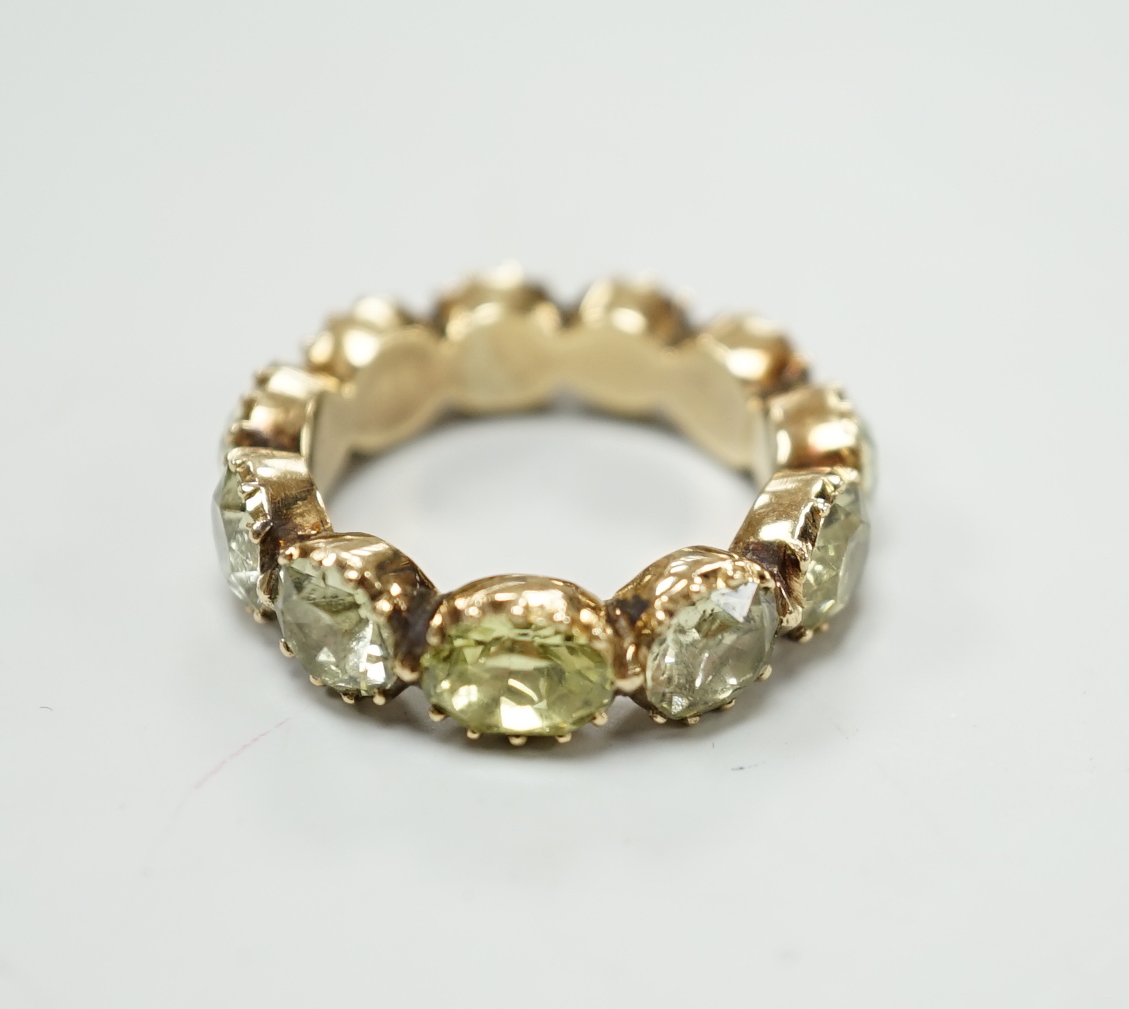 A 19th century green paste and yellow metal eternity ring, size L                                                                                                                                                           