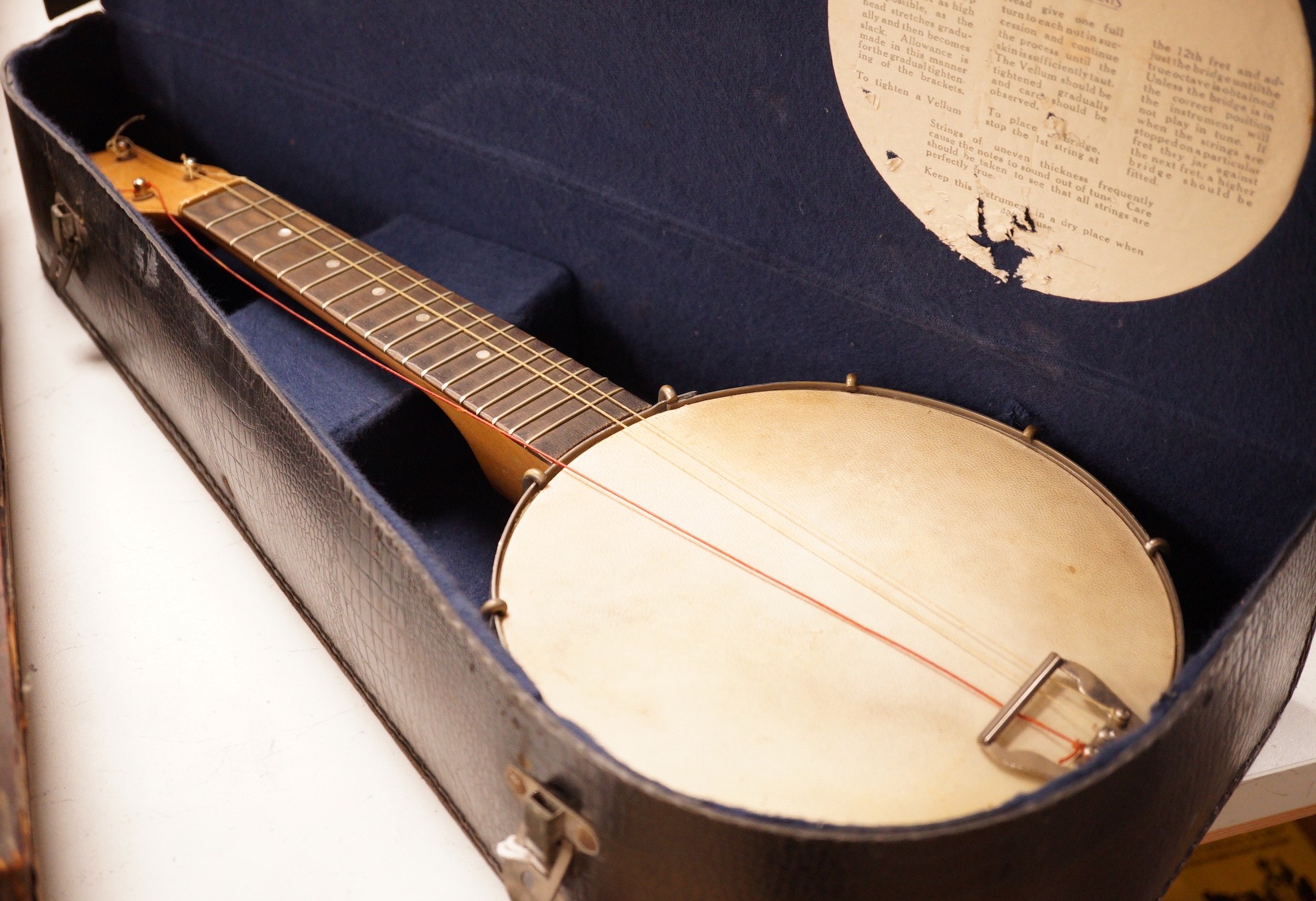 A ukelele banjo in case                                                                                                                                                                                                     