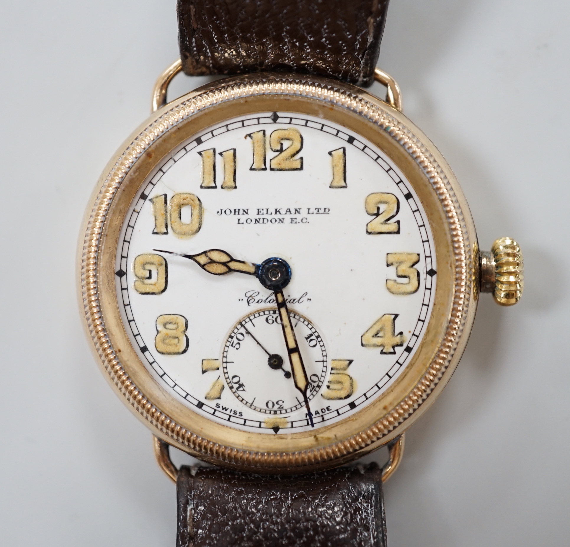 A gentleman's early 20th century yellow metal manual wind wrist watch, retailed by John Elkan Ltd, London, with Arabic dial and subsidiary seconds.                                                                         