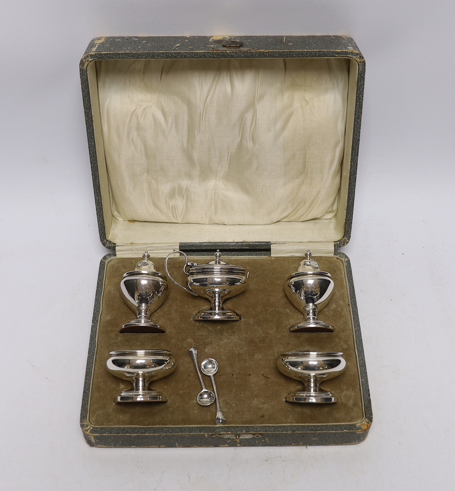 A cased George V silver five piece condiment set, Henry Clifford Davies, Birmingham, 1913 & 1917, with two associated plated spoons.                                                                                        