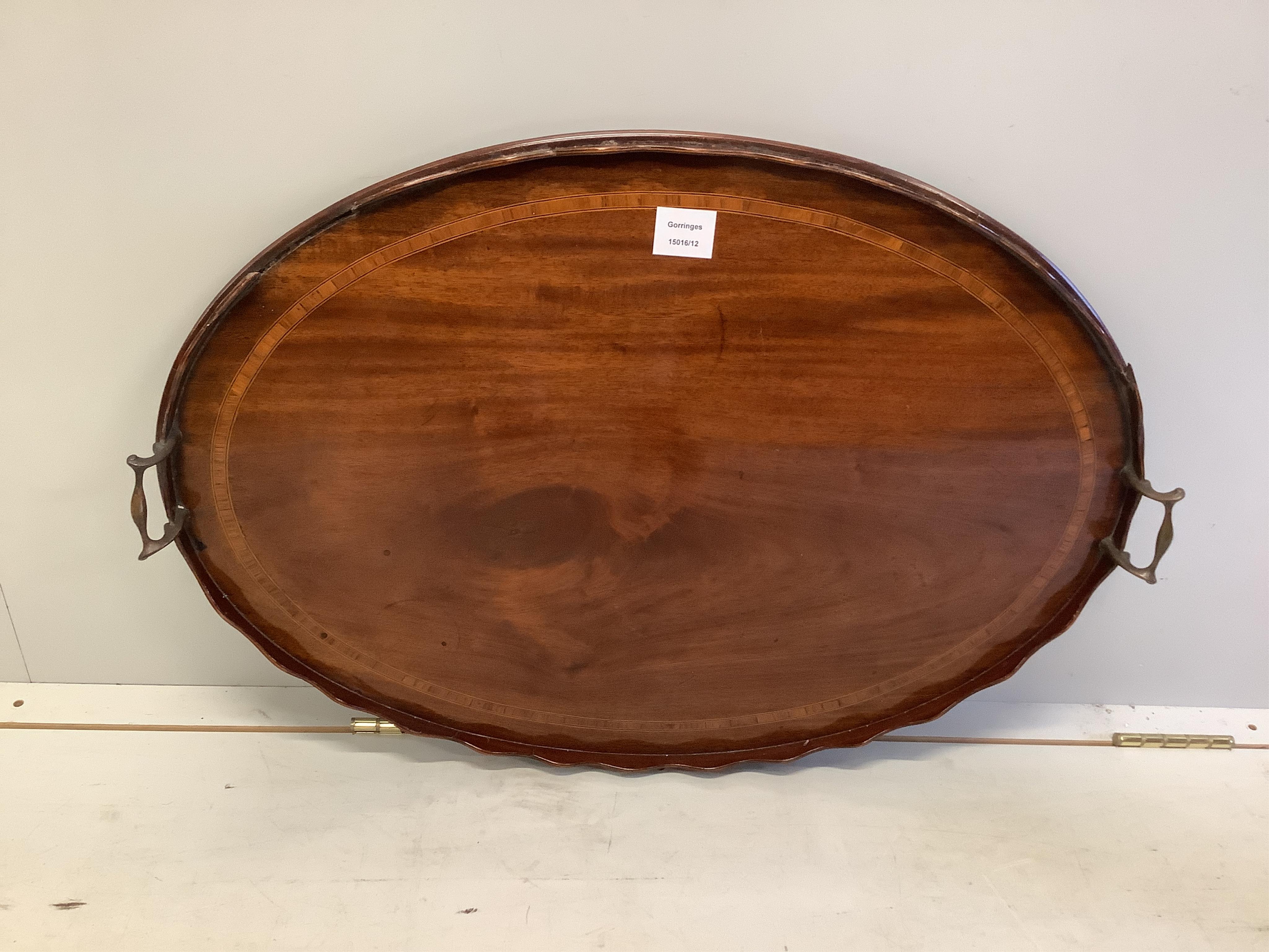 An Edwardian satinwood banded mahogany oval twin handled tea tray, length 73cm, depth 51cm. Condition - poor                                                                                                                