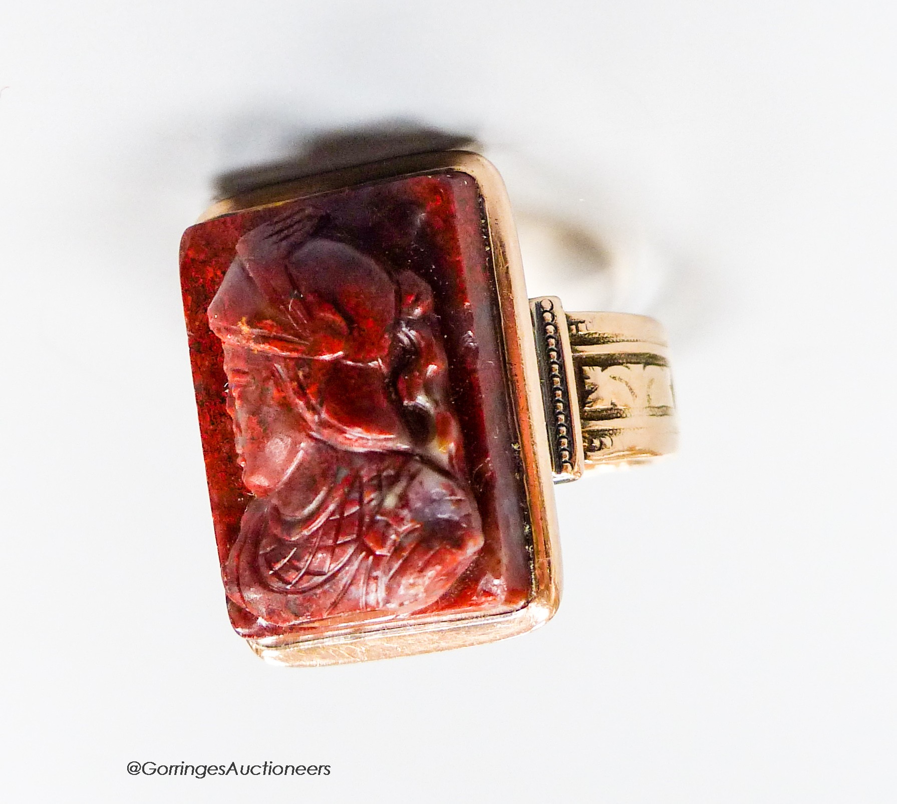 A 19th century yellow metal (stamped 14) and jasper? cameo ring, carve with the bust of a soldier to dexter, size P, gross 11.7 grams (a.f.).                                                                               