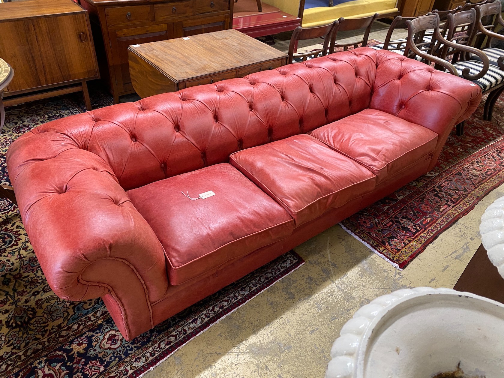 A Victorian style buttoned red leather Chesterfield settee, length 260cm, depth 90cm, height 68cm                                                                                                                           