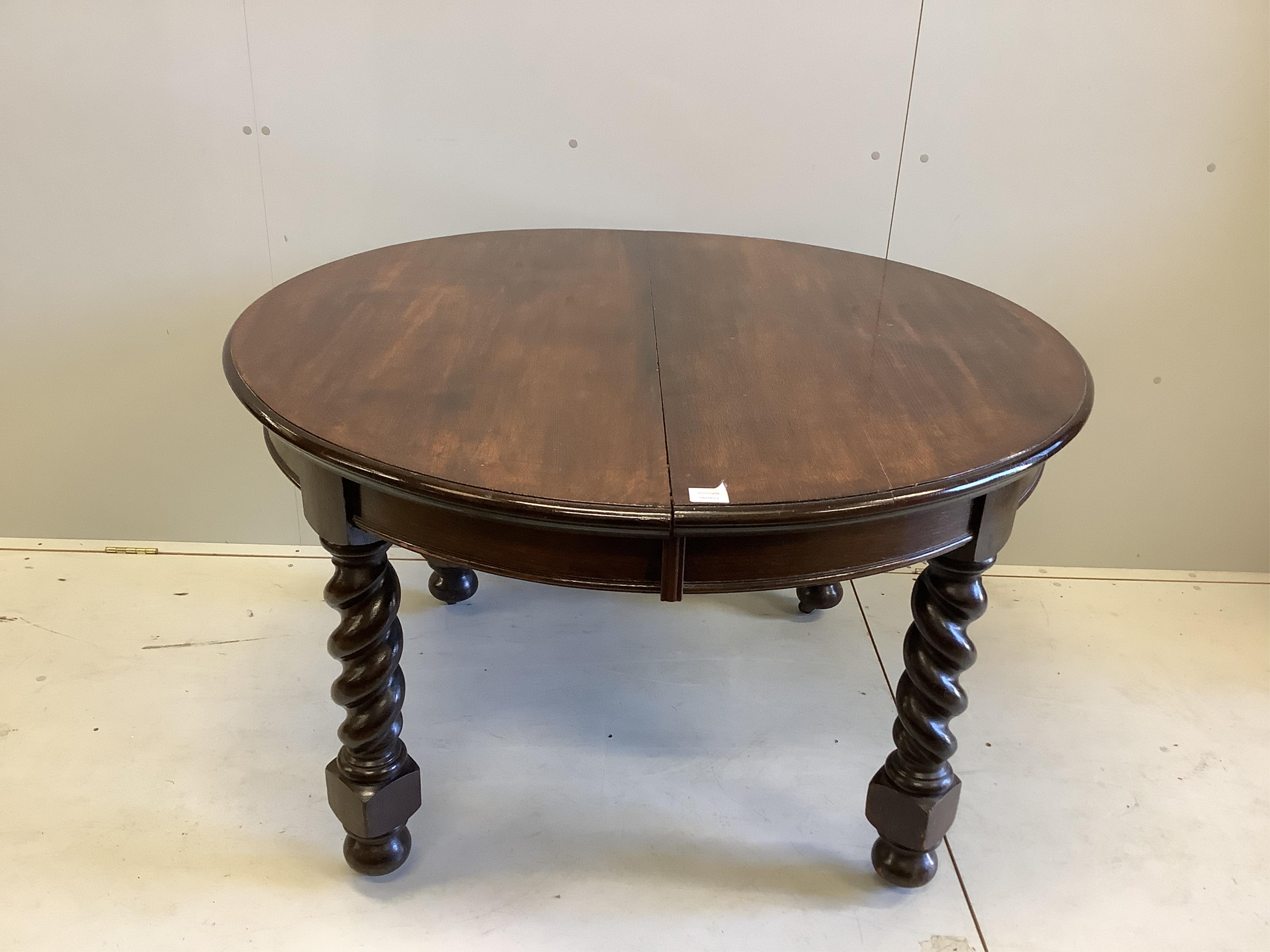 A 1920's oak 'D' end extending dining table, 234cm extended, two spare leaves, depth 120cm, height 74cm. Condition - fair                                                                                                   