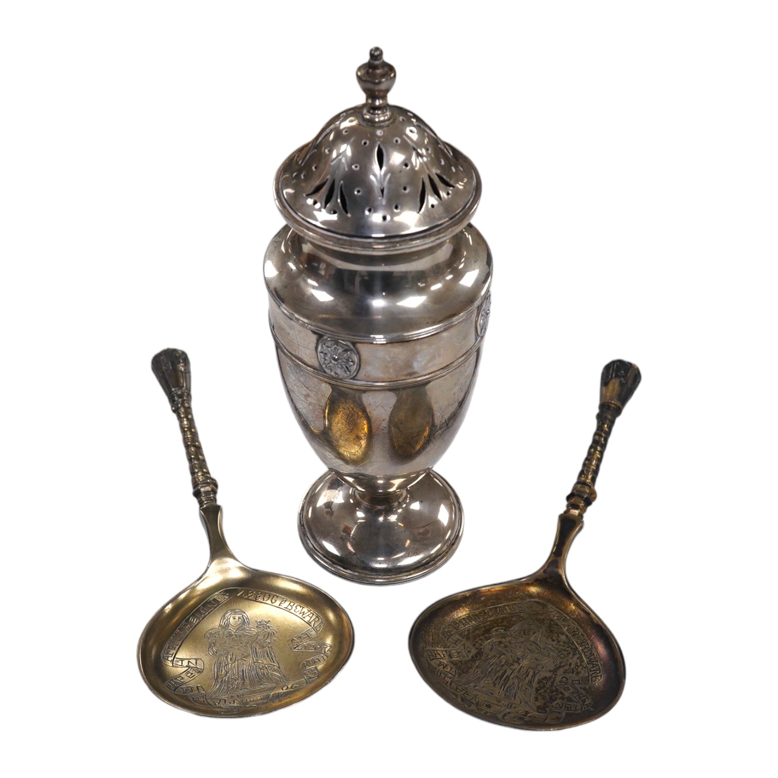 A George V silver sugar caster, by Harrod's Ltd, Sheffield, 1912, 18.4cm and a pair of Victorian commemorative spoons, Edward Pairpoint, London, 1878. Condition - fair to good.                                            