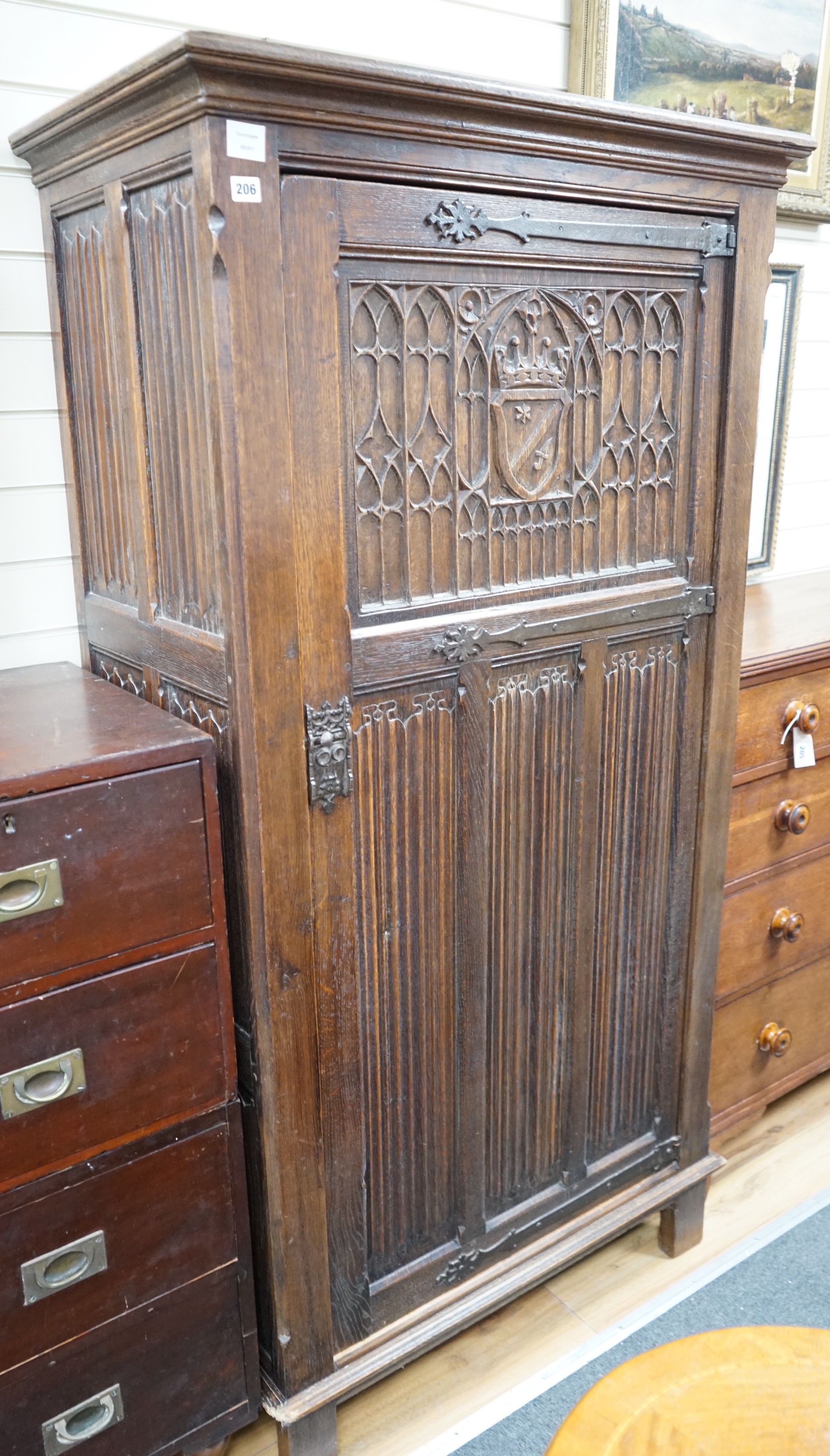 A 17th century style linenfold moulded oak hall cupboard, width 91cm, depth 53cm, height 179cm                                                                                                                              