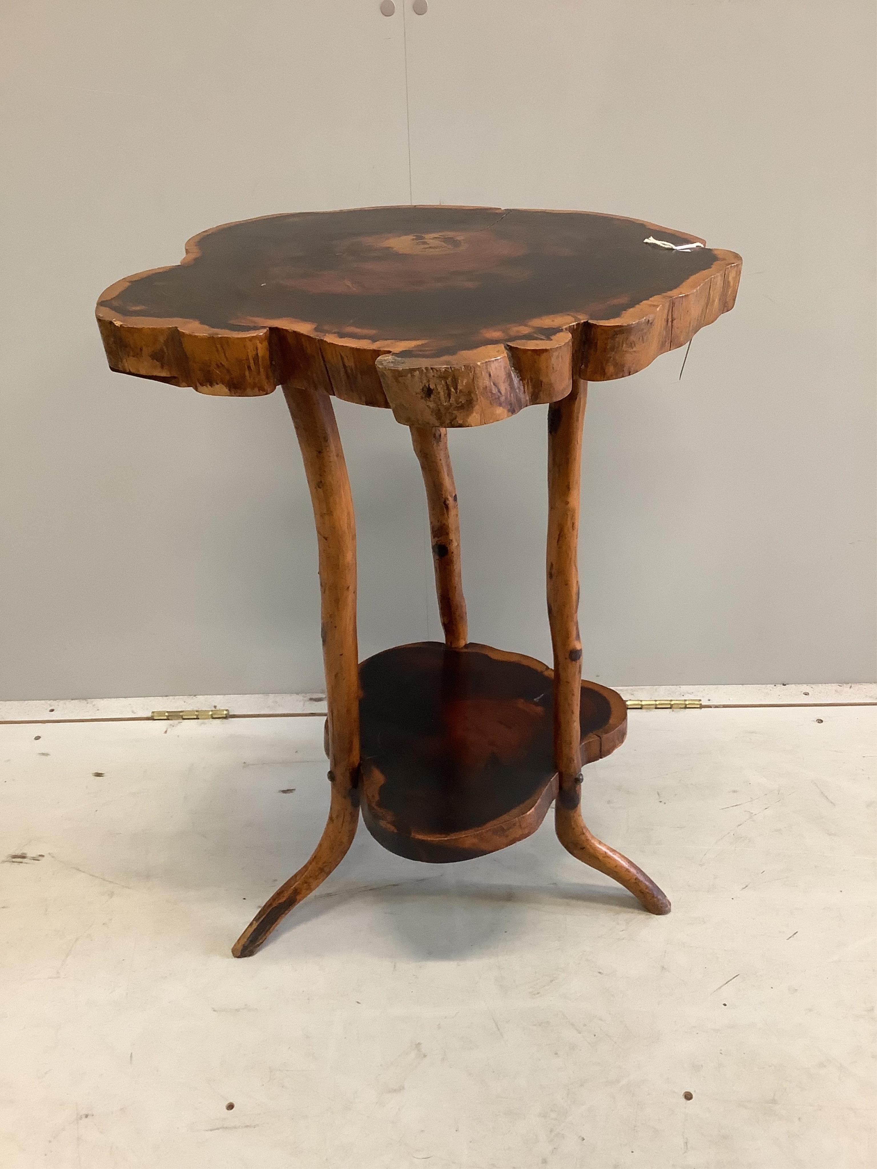 A rustic tree section two tier occasional table, width 52cm, height 73cm. Condition - fair                                                                                                                                  