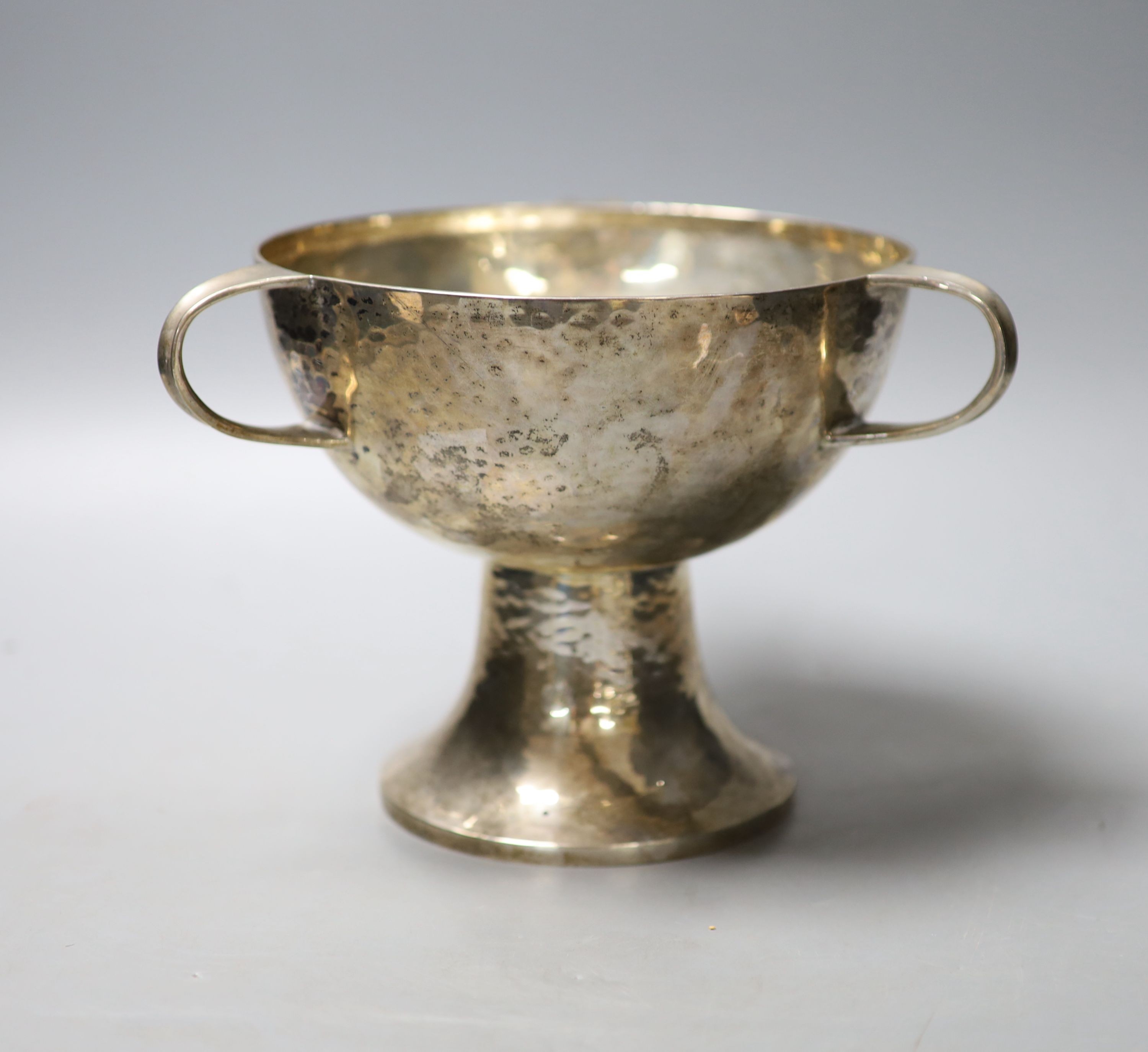 A George V Art Nouveau planished silver tri-handled pedestal bowl, by William Hutton & Sons Ltd, Sheffield, 1910, height 15.4cm, 16.5oz.                                                                                    