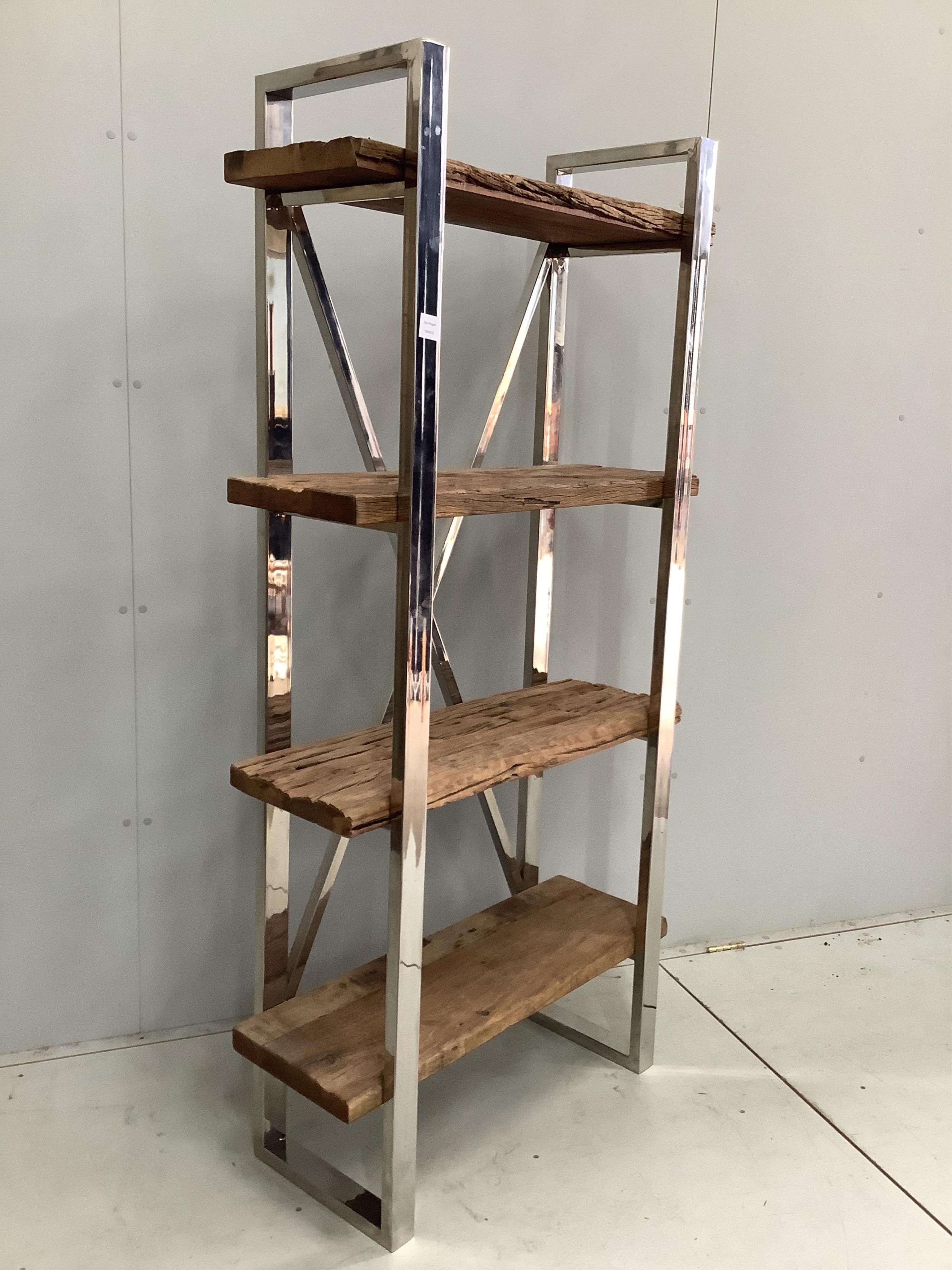 A Contemporary weathered hardwood and chrome set of open shelves, made from old train rail track woods, width 90cm, height 181cm. Condition - good                                                                          