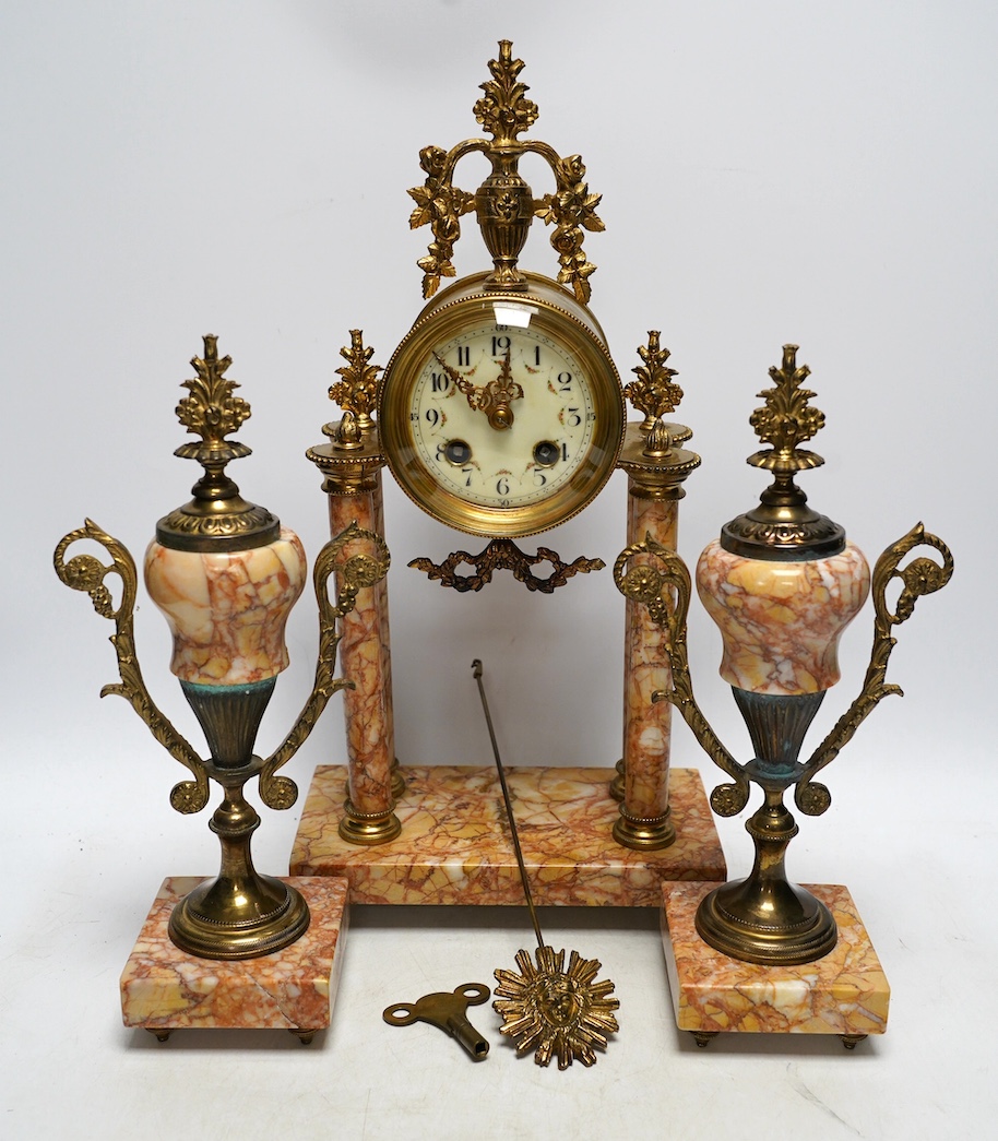 An early 20th century century French marble clock garniture, key and pendulum, 40cm. Condition - fair to good                                                                                                               