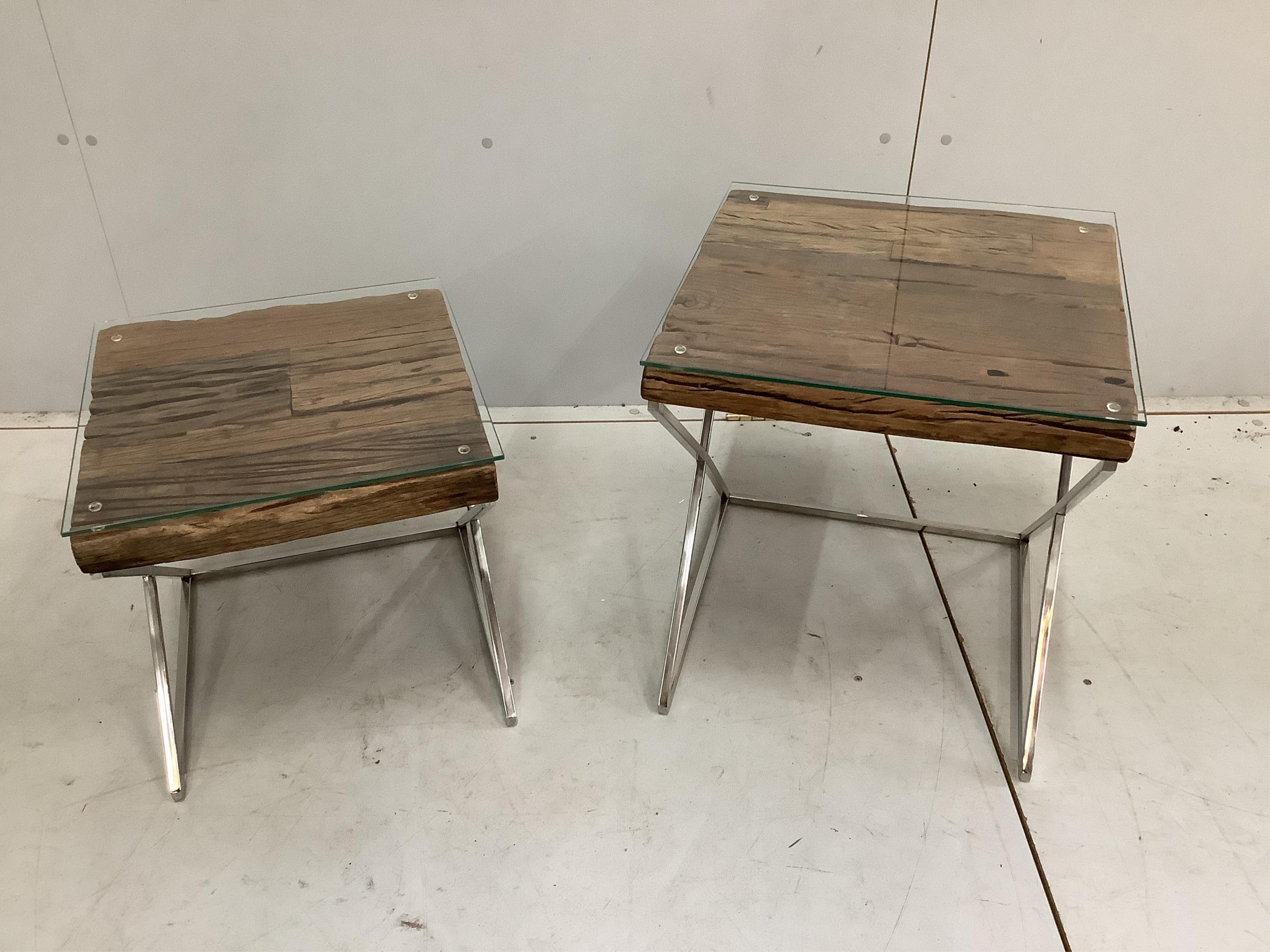 A stepped pair of Contemporary weathered timber and chrome occasional tables, the tops made from old train rail track woods largest width 45cm, height 44cm. Condition - good                                               