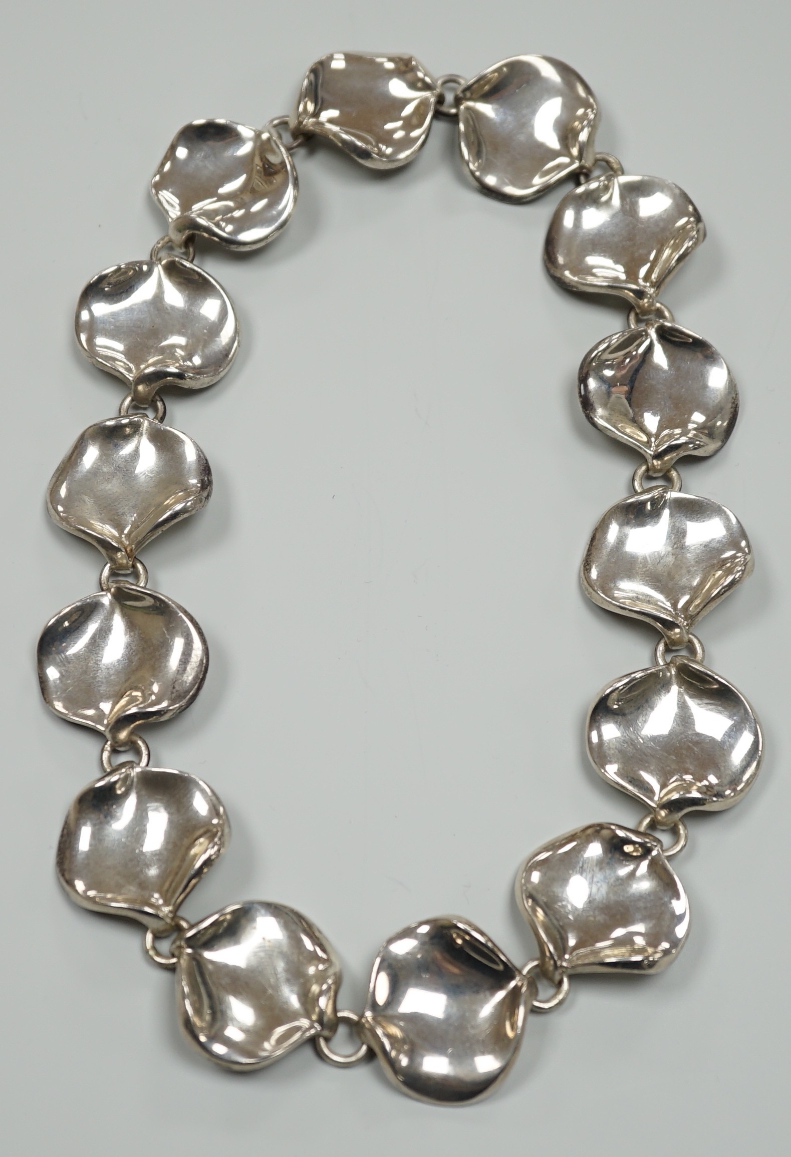 A modern Georg Jensen style silver necklace, with stylised petal links, maker AoL, London, 2008, 44cm, 189 grams.                                                                                                           