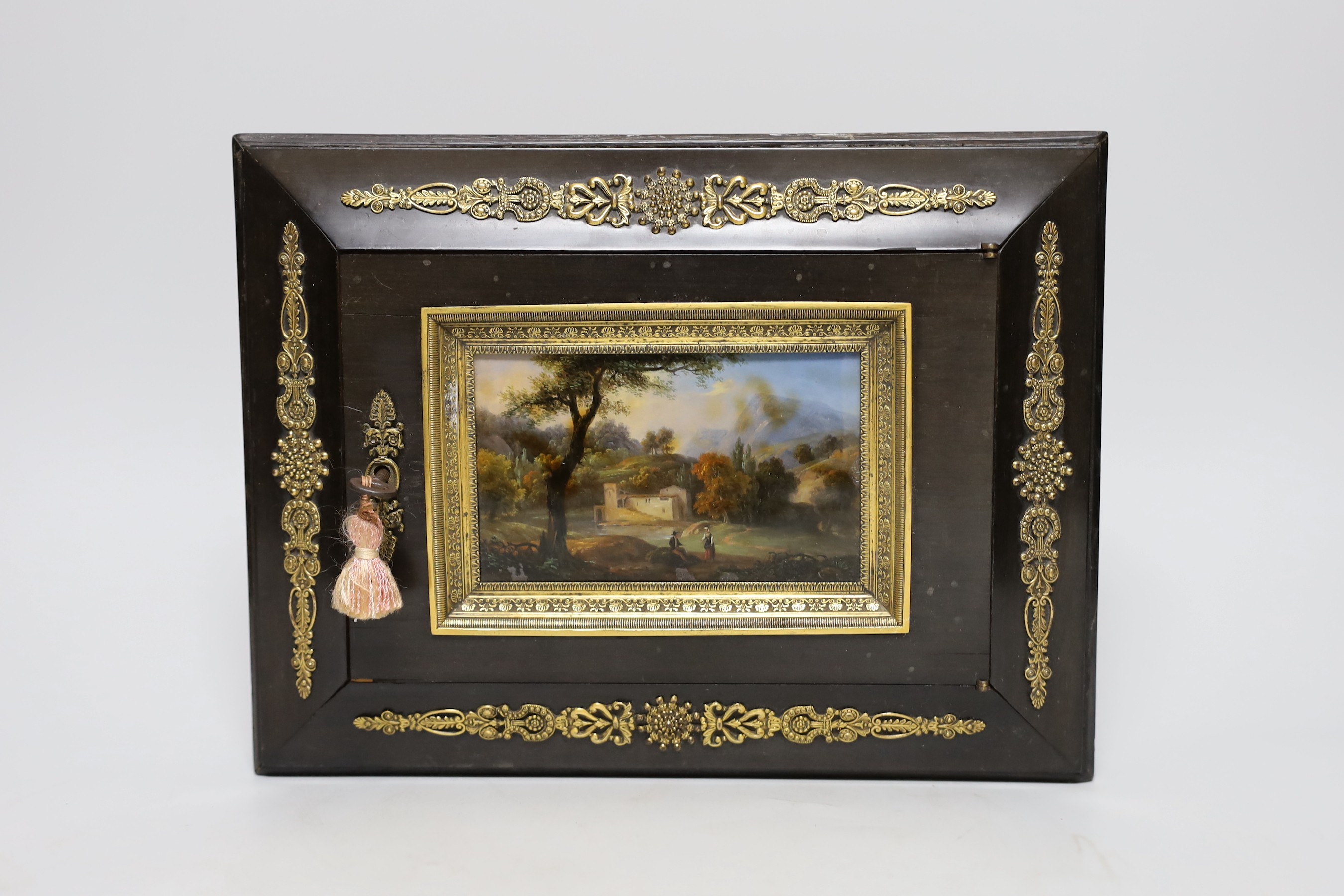 A 19th century French reverse painted glass, ebony veneered stationery safe box with ormolu mounts and red Morocco leather interior, makers mark Alph. Giroux, Paris, 28.5cms wide, 22cms deep                              