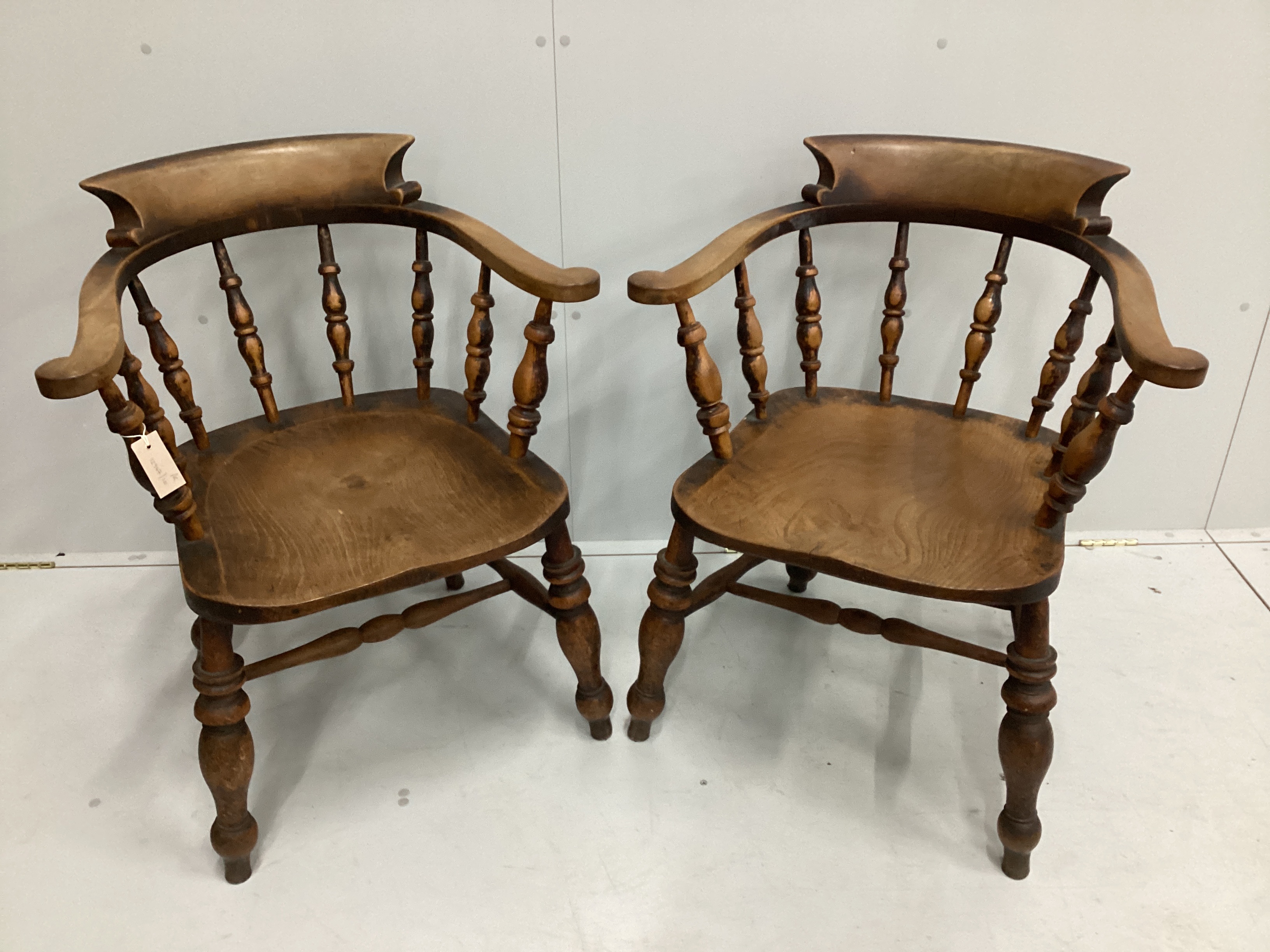 A pair of Victorian elm and beech smoker's bow elbow chairs, width 67cm, depth 50cm, height 82cm                                                                                                                            