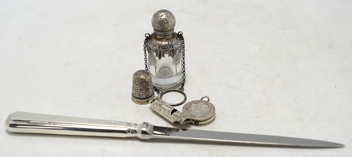 A late Victorian novelty propelling pencil modelled as two coins mounted on a central boss, diameter 24mm, together with a small late Victorian silver whistle, mounted scent flask, silver thimble and a modern Asprey silv