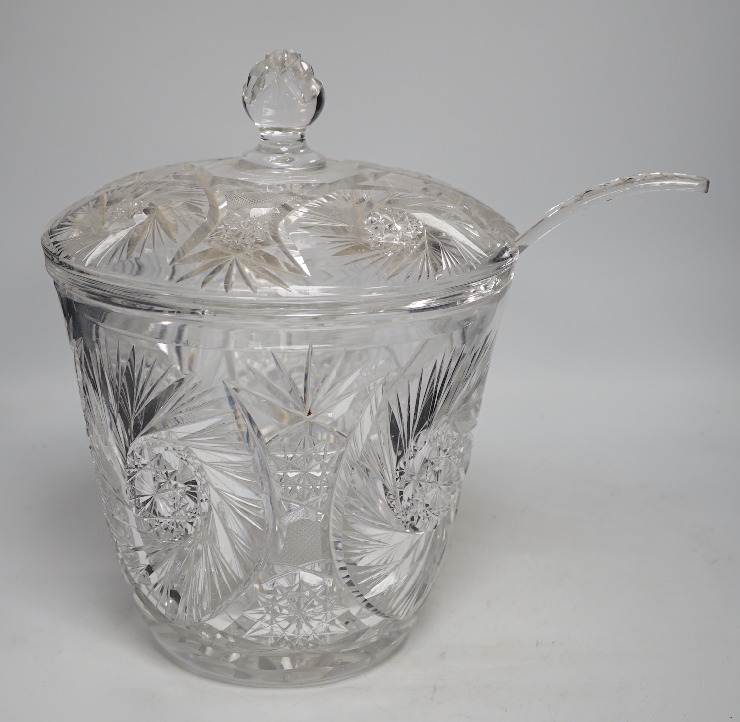 A large and heavy slice-cut lead crystal punch jar and cover, together with a ladle, 33cm                                                                                                                                   