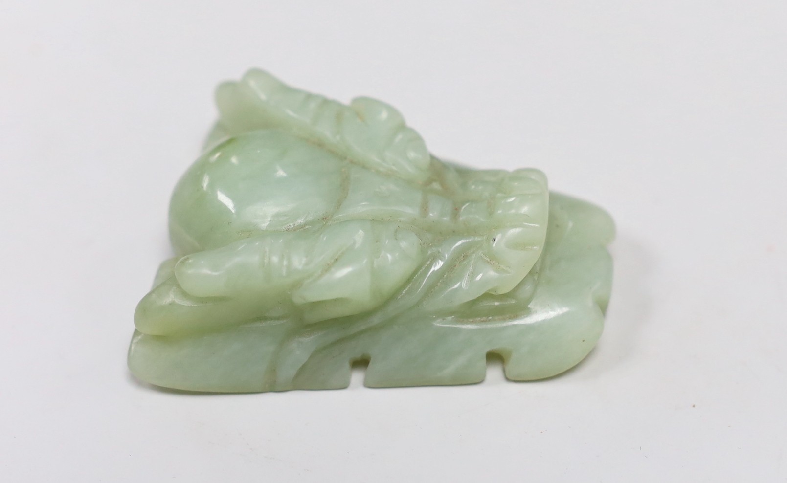 A Chinese bowenite jade dragon’s head belt buckle. 7cm wide                                                                                                                                                                 