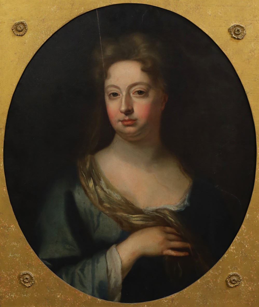 Circle of Sir Godfrey Kneller (British, 1646-1723), Portrait of a lady wearing a blue dress, oil on canvas, oval, 69 x 57cm                                                                                                 