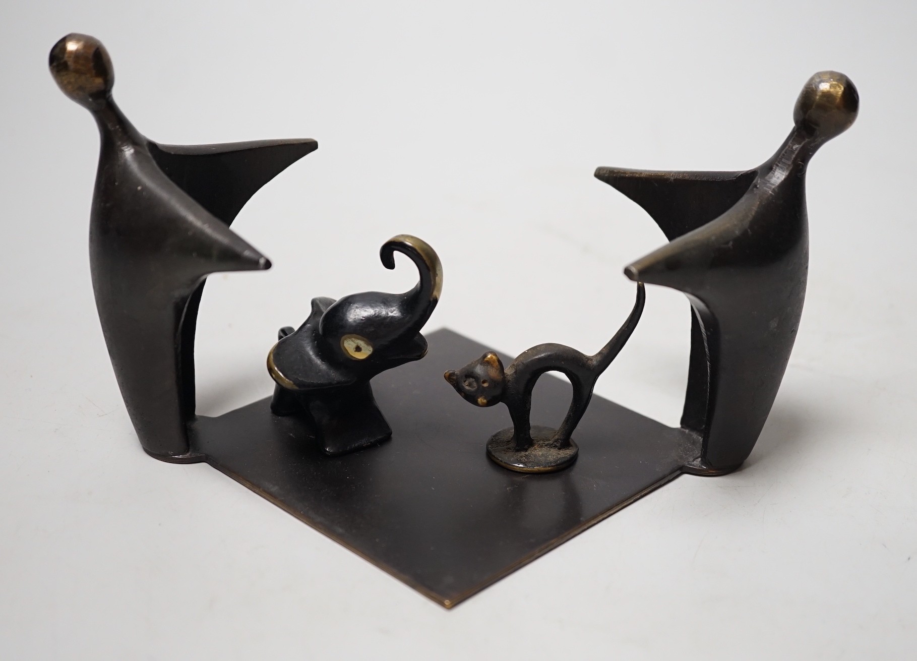 An abstract bronze group, 19cm wide, together with two other figures                                                                                                                                                        