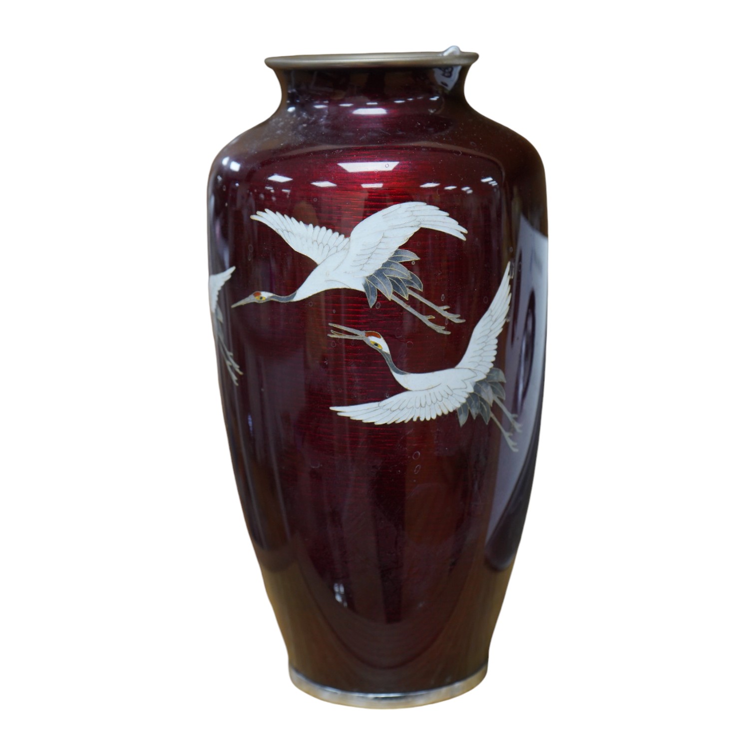 A mid 20th century Japanese cloisonné enamel red ground vase, inlaid with cranes, 21cm high. Condition - fair to good                                                                                                       