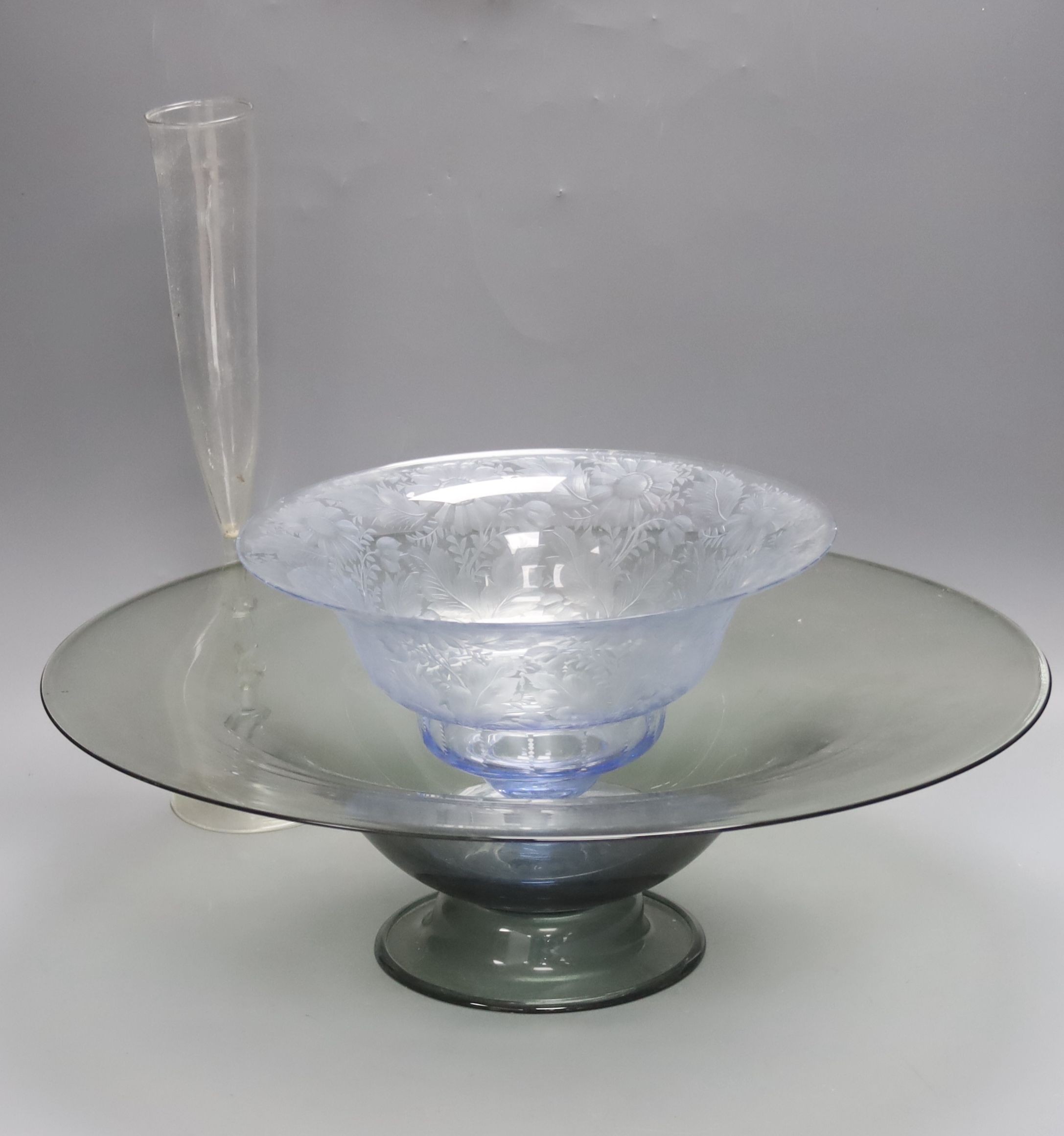 A Dutch Venetian style tall glass flute, the twisted stem with blue bead decoration, H 38cm, a 'Facon-de-Venise' style blue-tinted pedestal bowl, foliate-engraved and another glass dish (3)                               